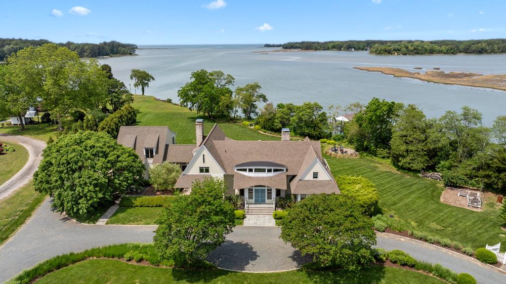 Custom-built waterfront home w/unobstructed bay & sunset views 2.32 acres. 5 bedrooms 4.5 baths. Wood & slate floors, Marvin windows, soaring ceilings & an abundance of natural light. Guest suite over garage. 44x42 pole barn, large garage doors for RV, heated & cooled workshop. Boat house, boat lift, boat dock 6' low tide water. Beautiful patios, decks & covered outside sitting areas. This is truly a one-of-a-kind ready to move in masterpiece. Appt required!