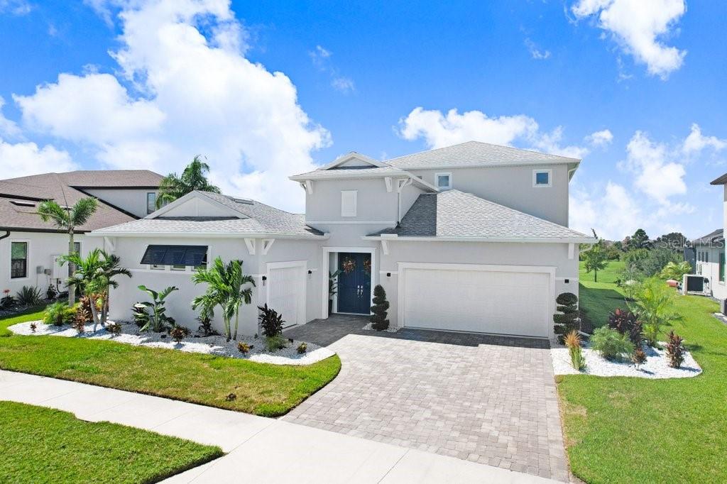A rare expression of South Florida resort living has arrived in Wesley Chapel. Welcome to 9260 Sanders Tree Loop, an award winning former Biscayne Homes model where dramatic architecture, exceptional privacy and effortless indoor outdoor living come together in a residence unlike virtually anything else in the area.At the heart of this extraordinary 5 bedroom, 4.5 bath Osprey 3 is its signature double entry courtyard, a breathtaking private open air oasis around which the home was designed. More than simply an outdoor space, the courtyard becomes an extension of the residence itself. Walls of glass open the interior toward a saltwater pool, oversized elevated spillover spa, expansive pavered entertaining areas and covered lanais, creating the atmosphere of a private resort beneath the Florida sun and stars. A detached, fully screened cabana with a complete outdoor kitchen and private pool bath makes entertaining equally effortless day or night.With approximately 3,335 heated square feet, a true 3 car garage and more than $465,000 in documented builder options and non standard upgrades, this is a home whose distinction is found not only in what you see, but in how it was built and designed. Concrete poured construction on both levels provides substantial structural construction suited to Florida living, while the residence has been professionally designed, decorated and incredibly maintained to preserve the presentation and character of its award winning model home origins.Inside, elegant design unfolds through light filled living spaces framed by walls of glass overlooking the courtyard. The chef’s kitchen is a showpiece with upgraded cabinetry, quartz countertops, a waterfall island and ceiling height glass backsplash. Coffered and tray ceilings, custom millwork and elevated designer finishes create architectural interest throughout while maintaining a warm, inviting atmosphere.The floor plan balances grand scale entertaining with private retreat. The owner’s suite is secluded on the main level, while additional bedrooms and an expansive bonus and game room occupy the second floor. Above the courtyard, a covered balcony creates yet another remarkable living space, perfect for morning coffee, evening cocktails or simply taking in the surroundings.And those surroundings are exceptional. Beyond the home, conservation and water create a peaceful natural backdrop, providing privacy, open views and spectacular western Florida skies. The combination of a private interior courtyard in front of this natural setting creates an extraordinary sense of escape that is difficult to replicate.For today’s executive or entrepreneur, the detached third garage bay has been professionally transformed into a climate controlled production and content studio, creating a dedicated environment for podcasting, video production, photography and creative work just steps from the residence.Offered fully furnished and move in ready, 9260 Sanders Tree Loop presents the rare opportunity to acquire an entire professionally curated lifestyle rather than spend years attempting to recreate one. Moments from Epperson’s celebrated Crystal Lagoon, this is South Florida style living in Wesley Chapel at its most compelling.A private courtyard. Resort inspired outdoor living. Conservation and water views. Award winning model home design. Extraordinary upgrades and exceptional condition.