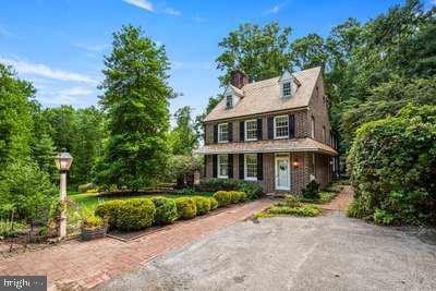 This one-of-a-kind, 3-acre private home is located down a private driveway tucked away in the woods. This beautiful home is a replica of the Betsy Ross house with colonial finishes appropriate to the period, including custom wood floors with square-cut nails. The doors have brass finishes and locks as well. The inglenook fireplace of the period is functional and has both a woodstove and gas logs for warming the living room and kitchen. The eat-in kitchen boasts 2 ovens, and 2 sinks, with one of each located in the island. All the appliances are high-quality and well suited for busy family use. The open floor plan is very welcoming and great for entertaining. The rear door leads to an expansive deck overlooking the pool, yard, fire pit, private pond and mature woods. Walk around to the back of the property to find swings and a hidden playground among the trees. The main house has a brand new cedar shake roof this year, and the garage is also getting a brand new cedar shake roof. This property is an active family's dream home - acres of woods, pool, pond, playground, privacy and plenty of space to expand. This is a must-see home! There is also an additional outbuilding with separate electric service, ready to be finished into an in-law suite, office, or workshop. Septic plans are included in the listing. Please note, the seller is preparing for an out-of-state move, so there may be more personal property throughout as a family of 7 prepares kids for not only a move but one going off to college this year. This home is well-loved and well cared for and ready for your family to make your memories in! Make sure you see the enclosed video.