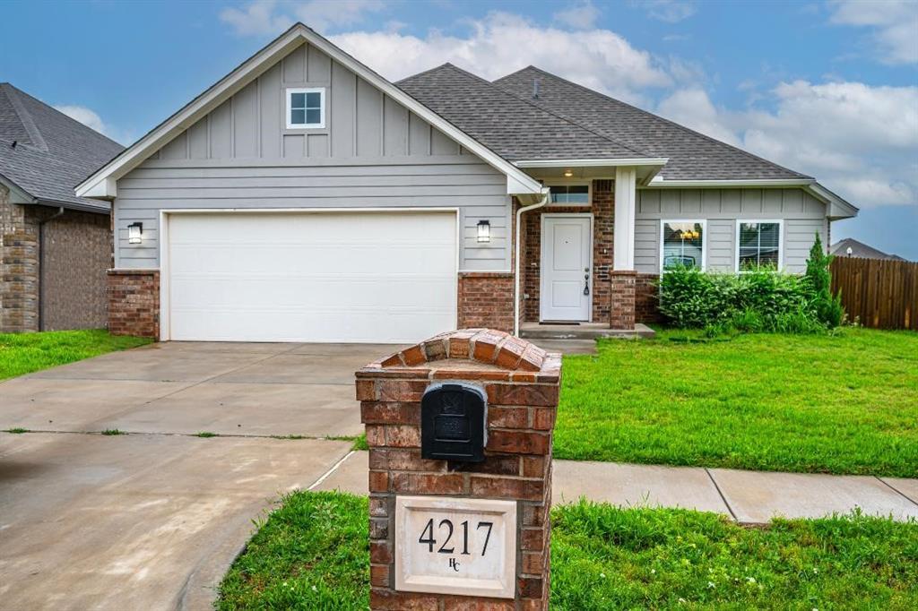 This spacious three-bedroom, two-bathroom home features an open-concept layout with a cozy fireplace in the living room and a chef’s kitchen complete with custom wood cabinets, stainless steel appliances, and a large island for extra counter space. Wood-look tile flows through the main living areas, adding warmth and style. A double sliding barn door leads to a generous bonus room perfect for a home office, playroom, or media space. The utility room offers built-in shelving for added storage. The oversized primary bedroom includes a spa-like ensuite with a doorless walk-in shower, double-sink vanity, and a soaker tub. Located on a desirable corner lot in the sought-after Lone Oak East community, which features a neighborhood pool, playground, and miles of sidewalks for outdoor enjoyment.