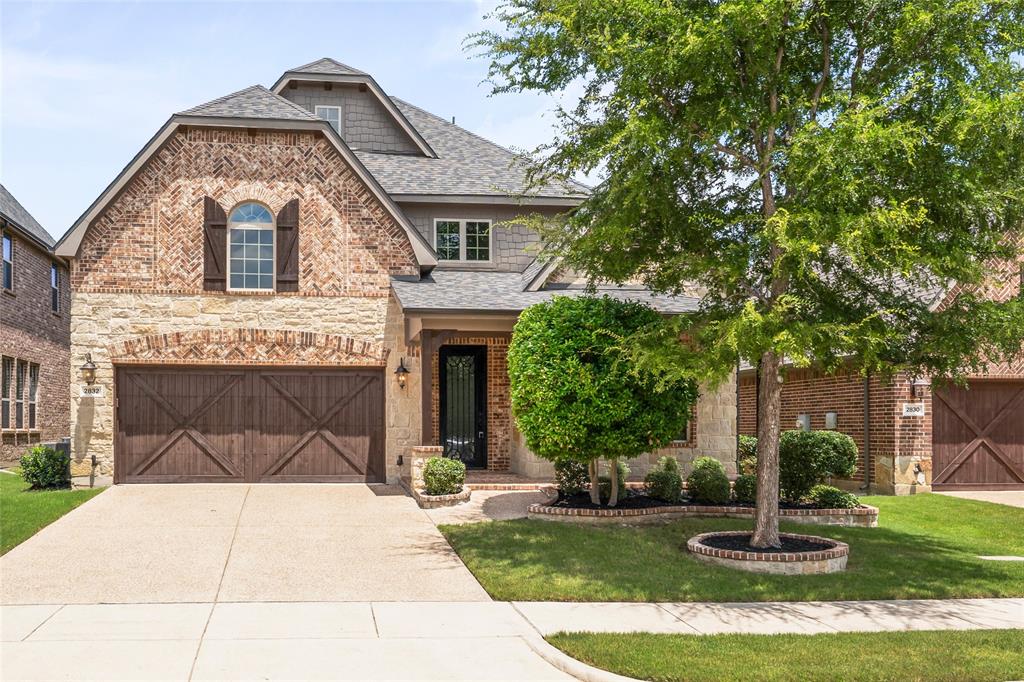 Located in the desirable Abbey Moor section of The Highlands at Trophy Club, this move-in ready 4-bedroom, 3.1-bath home offers great curb appeal with a charming front porch and elegant iron entry door. Inside, you'll find rich wood floors throughout much of the main floor including the private home office with French doors, a formal dining room, and a bright open-concept living area with a wall of windows and a stunning Austin stone fireplace with push-button start. The spacious kitchen features a large center island, electric cooktop with optional gas conversion, single-double oven, walk-in pantry, double granite sink, and opens seamlessly to the living space—perfect for everyday living and entertaining. The main-floor primary suite includes new carpet, a wall of windows, and a luxurious en-suite bath with dual vanities, a large soaking tub, a separate shower with new frameless glass doors, and a walk-in closet. Upstairs, enjoy a versatile game room and a full bath adjacent to a private bedroom—ideal for guests or multigenerational living—while two additional bedrooms share a Jack and Jill bath with individual sinks and walk-in closets. The extended back patio is designed for entertaining with a built-in grill and custom stone table with granite countertops. The two car garage offers extra pull down attic storage as well! All of this is located in the vibrant golf community of Trophy Club, offering residents access to a community pool and splash pad, dog park, scenic trails, parks, Lake Grapevine, and top-rated Northwest ISD schools—just 15 minutes west of DFW Airport with easy access to major highways. *NEW ROOF AND GUTTERS MAY 2025*