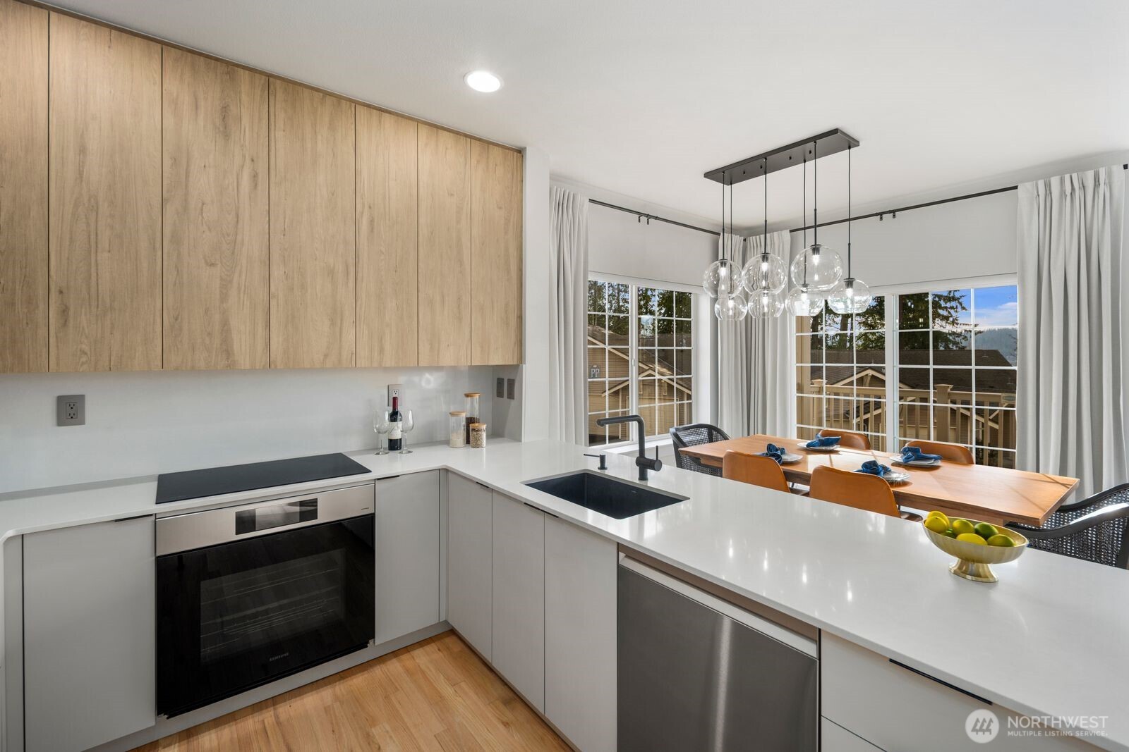 One-of-a-kind, light-filled end-unit townhome offering 4 bedrooms and a rare side-by-side 2-car garage. Expansive west- and south-facing windows flood the home with natural light year-round. Thoughtfully renovated and beautifully maintained, this home features a fully renovated kitchen with custom-made cabinetry, stone countertops, stainless steel appliances (AI-powered oven, induction cooktop, silent built-in hood, built-in microwave drawer), and designer finishes. Bathrooms have been fully renovated, delivering a modern, cohesive feel throughout the home. Fresh interior paint, new carpet, new windows, central A/C, a furnace-mounted home humidifier, and numerous system upgrades make this property truly move-in ready. Located in one of the area’s most sought-after school districts, this is a standout opportunity that seamlessly blends space, light, comfort, and quality updates. Minutes to Whole Foods, Target, and Costco. Convenient access to the Light Rail, SR-520, and the Microsoft campus. Walking distance to Lake Sammamish Beach and Marymoor Park. The townhouse also features a lake view.