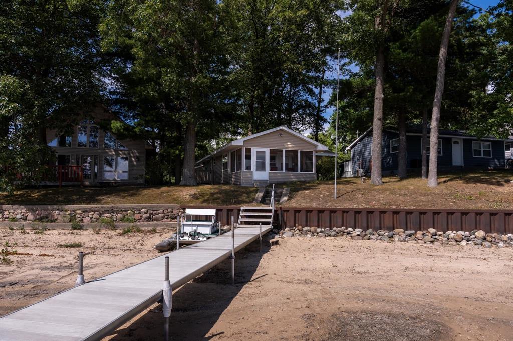 Charming 3-bedroom, 1-bath waterfront home on Eight Point Lake with 50 feet of frontage and a clean sandy bottom, ideal for swimming and boating. The smart floor plan makes efficient use of space, complemented by a spacious screened sunroom for enjoying lake views or just relaxing. Recent updates include new shingles and sunroom (2014), seawall (2016), Anderson windows (2019), electrical wiring (2020), and a new water heater (June 2025). The property also features a detached 2-car garage providing ample parking and storage. Eight Point Lake is known for excellent fishing, water recreation, sandbar gatherings, golf cart rides, summer concerts, and holiday events including the 4th of July 5k and Labor Day fireworks. Whether for seasonal use or year-round living, this home offers a great opportunity to enjoy all that lakefront living has to offer.