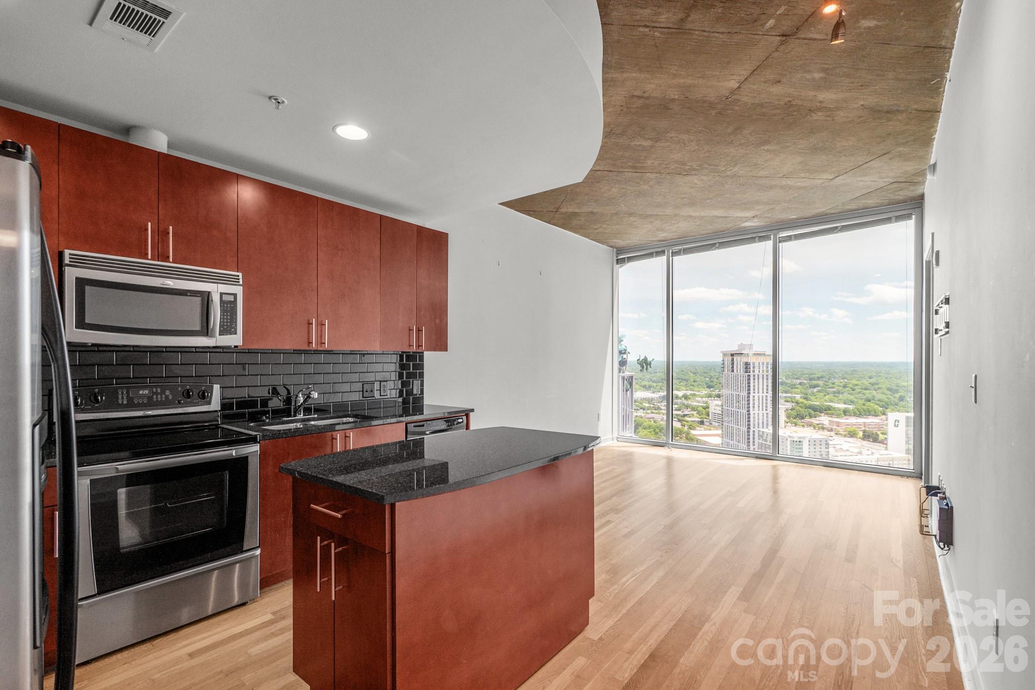 Experience luxury high-rise living in the heart of Uptown Charlotte at The Avenue! This stunning 31st-floor unit offers breathtaking city views, an open-concept layout, and floor-to-ceiling windows that fill the space with natural light. The modern kitchen features granite countertops and stainless steel appliances, while the spacious bedroom and private balcony provide the perfect retreat. Enjoy top-tier amenities, including a rooftop pool, fitness center, and concierge service. Step outside and find yourself just minutes from Romare Bearden Park, Truist Field, Spectrum Center, and some of Charlotte’s best dining and nightlife. With easy access to light rail, major highways, and cultural attractions, this is Uptown living at its finest! AC is new (2024). Water heater is new (2019). All new hardwood floor(2024) The mirror wall and customized closet are upgraded by the owner. The hardwood floor throughout  upgraded by the owner. High -speed wifi includes in HOA. The Unit has a deeded STORAGE unit (can be rent easily).