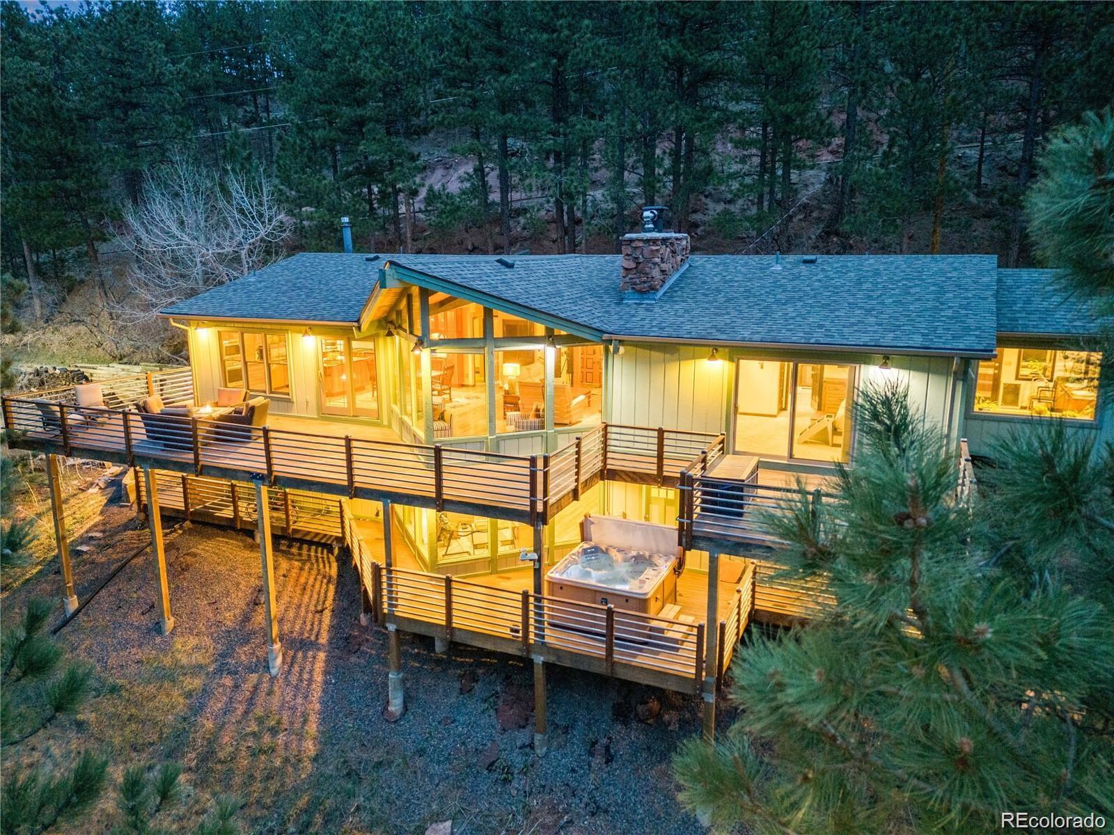 Welcome home to your mountain retreat just minutes from the heart of Boulder, Colorado!  Only seven minutes to the local grocer (Lucky's Farmers Market). This mountain home feels like a vacation get away! Sprawling views, sounds of nature, and ease of living with all you need right here.  Notice the thoughtful updates without taking away the charm of a mountain home.  Enjoy the fireplace that was designed with moss rocks found on the property when it was built.  Stunning uninterrupted views of the surrounding mountains, valleys and skies on your oversized IPE wrap around deck.  Beautiful Australian Cypress Hardwood floors adorn the open floor plan in the primary living space.  Not one detail was left out of the kitchen design for your culinary craft. Cherry soft close cabinetry, high-end Thermador appliances, recycling station, heating drawer, pot filler, six burner gas cooktop appliance garage, granite countertops. The primary bedroom boasts a huge walk-in closet, five-piece bathroom with heated tile floors, and a pet door for ease of letting them go in and out while staying protected from wildlife. The lower level is a great place to unwind and watch a game/movie or walk out to the deck and slide into your four-person hot tub for a nice soak. There are two bedrooms with a walk-through bathroom (also with heated floors) for your kiddo's or guests. The roof is only two years old.  All new interior and exterior paint, septic has been certified with the county of Boulder, boiler was recently serviced, and the home is MOVE IN READY! There is a fire hydrant at the beginning of the driveway, and the home is on a school bus route, which ensures it will be plowed by the city of Boulder. The home is an insurable mountain property.  Seller is very motivated!  Bring your creative ideas on how to make this home your dream come true.  Reach out to me, the listing agent, and I can answer any questions you may have.  720.442.5413