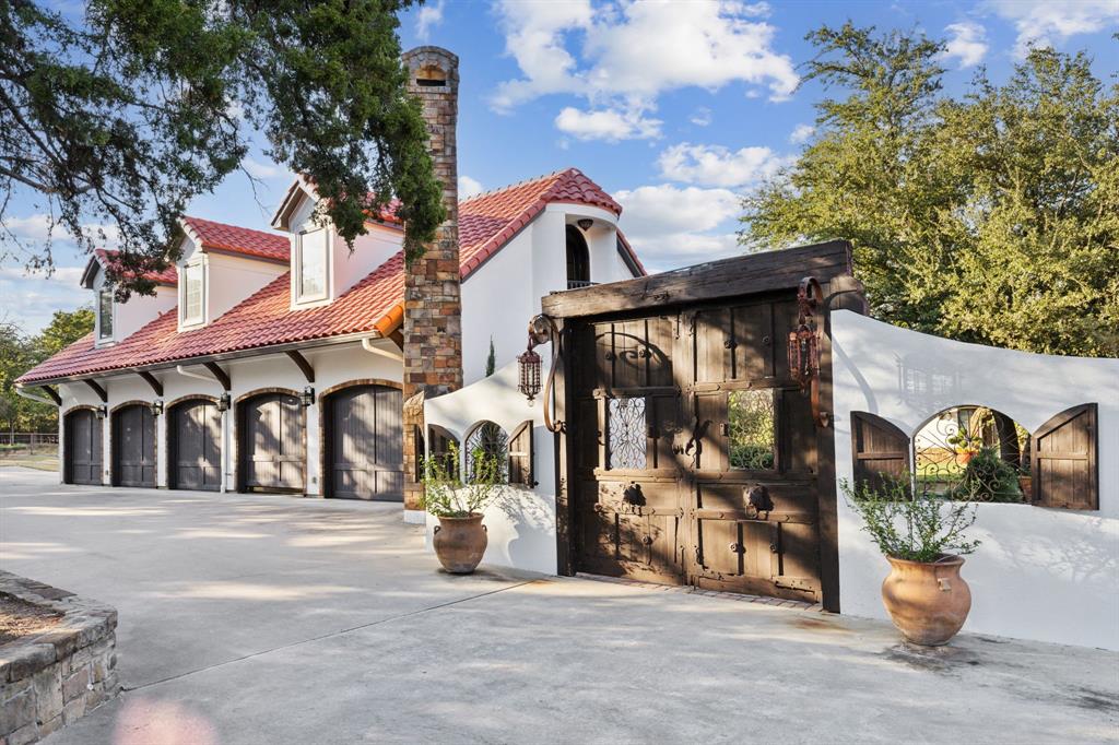 Hard to find almost 10 acres in Southlake!!!! Value in the land alone. Enjoy ultimate luxury living with this extraordinary Spanish resort-style estate. Plenty of room for cattle or horses. Mature oak trees surround this private, gated retreat located within highly sought-after Carroll ISD. This stunning property offers 8,882 square feet of refined living space, including 5 bedrooms, 7 baths, and a thoughtfully designed layout that seamlessly blends indoor elegance with outdoor serenity. The primary residence features grand living areas, soaring ceilings, and timeless architectural details throughout. Beautifully updated kitchen with Sausalito tile, Taj Mahal quartzite countertops and separate patio for morning coffee. Large updated family room overlooking both front yard and backyard courtyard with timeless fountains. Elevator makes it easy for upstairs access. Step into your backyard paradise where a sparkling pool, custom water fountains, and outdoor kitchen for unforgettable entertaining. Multiple outdoor living and dining areas invite you to relax and unwind amid nature's beauty. A separate carriage house above the garage provides flexible space for guests or extended stays, while the 5-car showcase garage is a collector’s dream. This estate is a rare blend of natural beauty, resort-style amenities, and refined comfort—truly one of Southlake’s hidden gems.