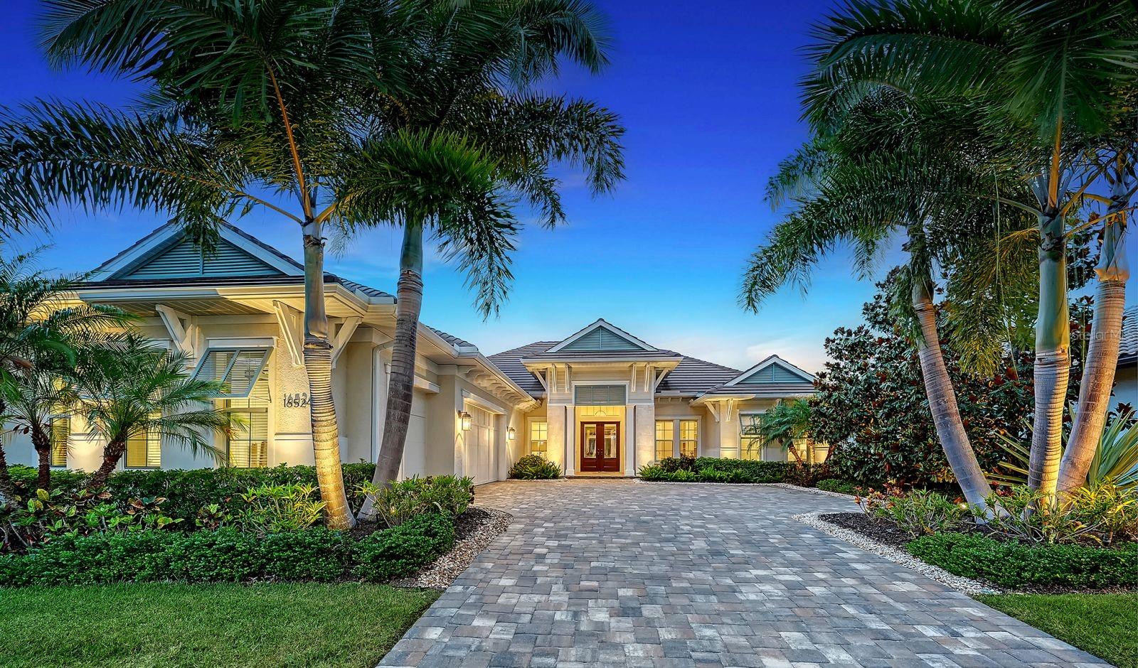 Welcome to an extraordinary expression of luxury living in Country Club East—where timeless design meets modern comfort in this impeccably crafted Lee Wetherington custom residence. Perfectly positioned to capture tranquil lake views, this 3-bedroom, 3-bath home offers a refined yet relaxed lifestyle in one of Lakewood Ranch’s most coveted gated neighborhoods.From the moment you enter, you’re greeted by elegant finishes, upgraded flooring, and detailed crown molding that elevate the home’s refined ambiance. The open-concept design seamlessly connects the main living spaces, creating an inviting setting ideal for both everyday living and entertaining. At the heart of the home, the gourmet kitchen impresses with a gas range, custom vent hood, expansive island with seating and storage, and thoughtfully selected high-end finishes.The spacious great room flows effortlessly to a private office with custom built-ins and a versatile bonus room, offering flexibility for work or leisure. Each bedroom is a private retreat with its own en-suite bath, ensuring comfort for family and guests alike. The primary suite is a serene haven, featuring dual walk-in closets, bay windows with sitting area, and a spa-like bath with dual vanities, soaking tub, and an oversized walk-in shower.Step outside to your personal oasis, where impact-rated sliders open to a covered lanai, fully equipped outdoor kitchen, built-in gase firepit and sparkling pool—all set against peaceful water views. Lush landscaping and curated exterior lighting create a picturesque backdrop both day and night.Additional highlights include impact glass windows and doors, a desirable 3-car side-load garage, and close proximity to championship golf, upscale dining, boutique shopping, and the vibrant lifestyle that defines Lakewood Ranch.Experience the perfect balance of elegance, comfort, and Florida resort-style living—this exceptional home is ready to impress.