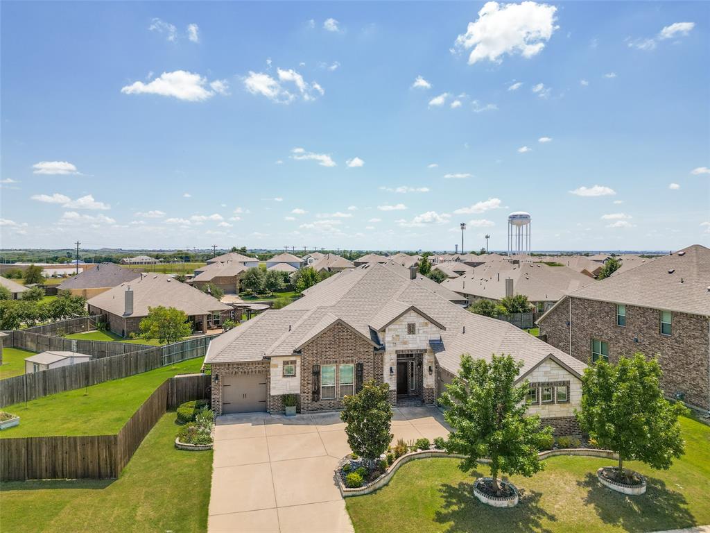 Easy 25 mile commute to downtown Dallas from I-30 or Highway 80 located in the Heath - Rockwall school district! This open-concept home blends elegant design with high-end finishes, perfect for both everyday living and entertaining on an oversized lot. The chef’s kitchen showcases an oversized island, granite countertops, stainless steel appliances, and abundant storage. Connected spaces—including a formal dining room, spacious family room, and inviting covered porch—make hosting effortless. A fifth bedroom offers flexibility as a home office or media room, while the primary suite features a spa-inspired bath and expansive walk-in closet. Additional highlights include a three-car garage and a private hot tub for relaxing evenings. The wooden fence was moved 24 ft closer to the street, with a double gate added for extra wide entry. The lot size itself is one of the largest in the neighborhood, perfect for a pool, sports and pets! The amenities at Lakeside at Heath includes a state-of-the-art pool center as well as fishing ponds.