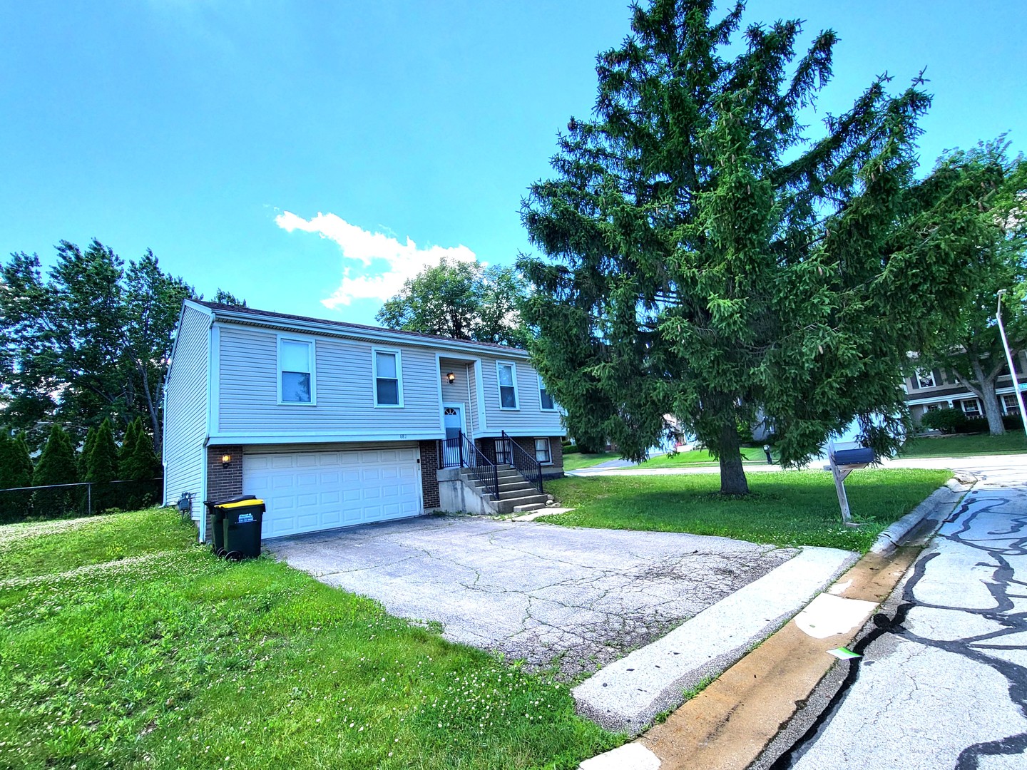 This super bright corner-lot home has a fantastic floor plan and tons of natural light. Freshly painted throughout, the upper level features a huge living room, dining room, and a beautiful kitchen with sliding doors leading to a great-size deck-perfect for relaxing or entertaining. Enjoy the paved patio underneath or use for storage, and a large yard with plenty of room for all your year-round activities. The lower level offers a huge flexible space that can be used as an entertainment area, office, lounge, or additional living space, plus a half bathroom and laundry and direct access to the attached garage. Great Carol Stream location close to shopping, restaurants, parks, trails, and major highways. A bright, spacious home with plenty of room to make it your own!