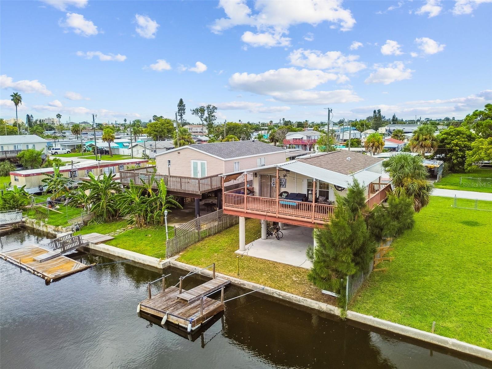 Dreaming of a waterfront lifestyle? This beautifully remodeled 2-bedroom, 2-bathroom stilt home sits on a deep-water canal with its own private boat dock and offers direct Gulf of Mexico access—just minutes to open waters. Located down the street from Hudson Beach with public boat docking, restaurants, and entertainment, this move-in-ready home features an open floor plan, updated finishes, and a wrap-around balcony on two sides—perfect for enjoying stunning sunsets. Major updates include the roof in 2020, 2021 HVAC, and 2020 hot water heater. The fenced yard is ideal for pets, and the elevated design provides ample covered parking for vehicles, golf carts, or recreational toys. With no HOA or deed restrictions, this property is perfect as a full-time residence, vacation retreat, or investment opportunity.