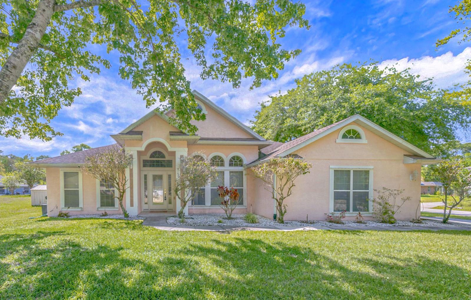 NEW ROOF INSTALLED PRIOR TO CLOSING!!! ALL SQUARE FOOTAGE IS NOT THE SAME as is demonstrated in this ONE-OWNER CUSTOM-BUILT “TODAY HOME,” which strikes a stately pose and is sweetly situated on a QUARTER ACRE+ PARCEL with NO HOA and a SIDE ENTRY GARAGE!  This is the same builder and same design set on high-end estates constructed throughout Volusia County.  These are timeless homes that age with GREAT BONES and loads of character!The exterior elevation is graced with MODERN ROMAN ARCHES—three aligning atop the right-side windows and two crowning the front entry where SIDELIGHTS and an UPPER TRANSOM frame the door…all assuring the home will be flooded with an abundance of natural light.  The architectural lines continue inside, where soaring 10” arches mirror and meet soaring 12’ ceilings above, and beneath a CONTINUOUS NEUTRAL-COLORED CERAMIC TILE flows seamlessly.  A TWO-WAY WOOD-BURNING FIREPLACE is set between them with a quiet elegance and a welcoming presence. The home blends the best of OPEN CONCEPT living—bringing together spacious gathering areas and touches of modern tradition—to the left is the living room…and to the right a magnificent dining room, both formal and fabulous!  Extending and enhancing casual living, ceilings in the GREAT ROOM soar even higher, where EIGHT-FOOT DOUBLE SLIDERS—one of THREE sets—open to a 23' COVERED and SCREENED LANAI. Furniture placement offers flexibility, with natural focal points centering around the fireplace and a generous wall accommodating about any oversized television.The kitchen offers 42" STACKED CABINETRY with CROWN MOLDING, UNDER-COUNTER LIGHTING, and GRANITE COUNTER TOPS spanning two walls for generous prep and storage. SS APPLIANCES and a DEEP DOUBLE-BASIN SINK add a polished touch!  A conveniently located LAUNDRY ROOM with UTILITY SINK and a light-filled DINETTE complete the space. The PRIMARY is luxurious in its sheer size with an expansive BAY WINDOW BUMP-OUT that serves well for a HOME OFFICE or reading nook. Highlights in the ENSUITE include elongated DOUBLE SINK VANITY, JETTED TUB, GLASS TILES, PRIVATE WATER CLOSET, and a WALK-IN CLOSET.   The SPLIT-BEDROOM FLOOR PLAN is thoughtfully arranged with two secondary bedrooms on the opposite side of the home sharing a private hallway, linen closet, and a second bath. Set in the shadows of Lake Helen, the location is an easy 30 minute commute to all things Orlando and Florida’s famous beaches and minutes from large box-store shopping...yet it still honors and protects the solitude of peaceful afternoons and serene evenings.  ADDITIONAL IMPROVEMENTS AND UPGRADES INCLUDE:  NEW HOT WATER HEATER (2026), WATER SOFTENER, IRRIGATION, RAIN GUTTERS, HARD WIRED SECURITY SYSTEM, and SURROUND SOUND STEREO SYSTEM.