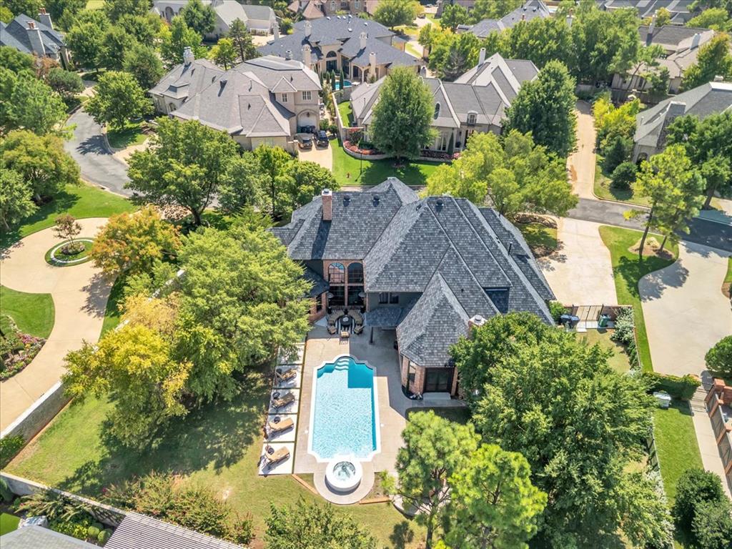 Incredibly Remodeled Luxury Estate in the Heart of Gaillardia. This beautifully reimagined estate blends timeless elegance with modern sophistication. From top to bottom, no detail has been overlooked in this comprehensive remodel.
Step inside to find rich hardwood floors, designer lighting, and fresh paint throughout. The sweeping rolling staircase with a contemporary iron railing sets the tone for the home’s upscale style.
The main-level primary suite is a true retreat, boasting an expansive walk-in closet, heated floors, and a spa-like bathroom with a soaking tub and luxurious walk-in shower. A secondary bedroom on the first floor provides comfort and convenience for guests or family.
Upstairs, you’ll find two additional bedrooms, including a second primary-style suite with its own walk-in closet and large private bathroom. A theater room with kitchenette and an upstairs pantry make the second floor perfect for entertaining and everyday living.
Designed for both comfort and gatherings, the home also features two spacious living rooms on the main level and a dedicated wine room off the kitchen. The chef’s kitchen offers abundant storage and flows seamlessly into the living spaces with a large built in bar connecting the two living spaces and uniting the doors put to the pool. Outdoors, the resort-style backyard is the ultimate retreat, showcasing a newly remodeled pool, expansive patio, and a stone fireplace—ideal for year-round enjoyment.This estate combines luxury, functionality, and sophistication, offering the perfect backdrop for refined living.