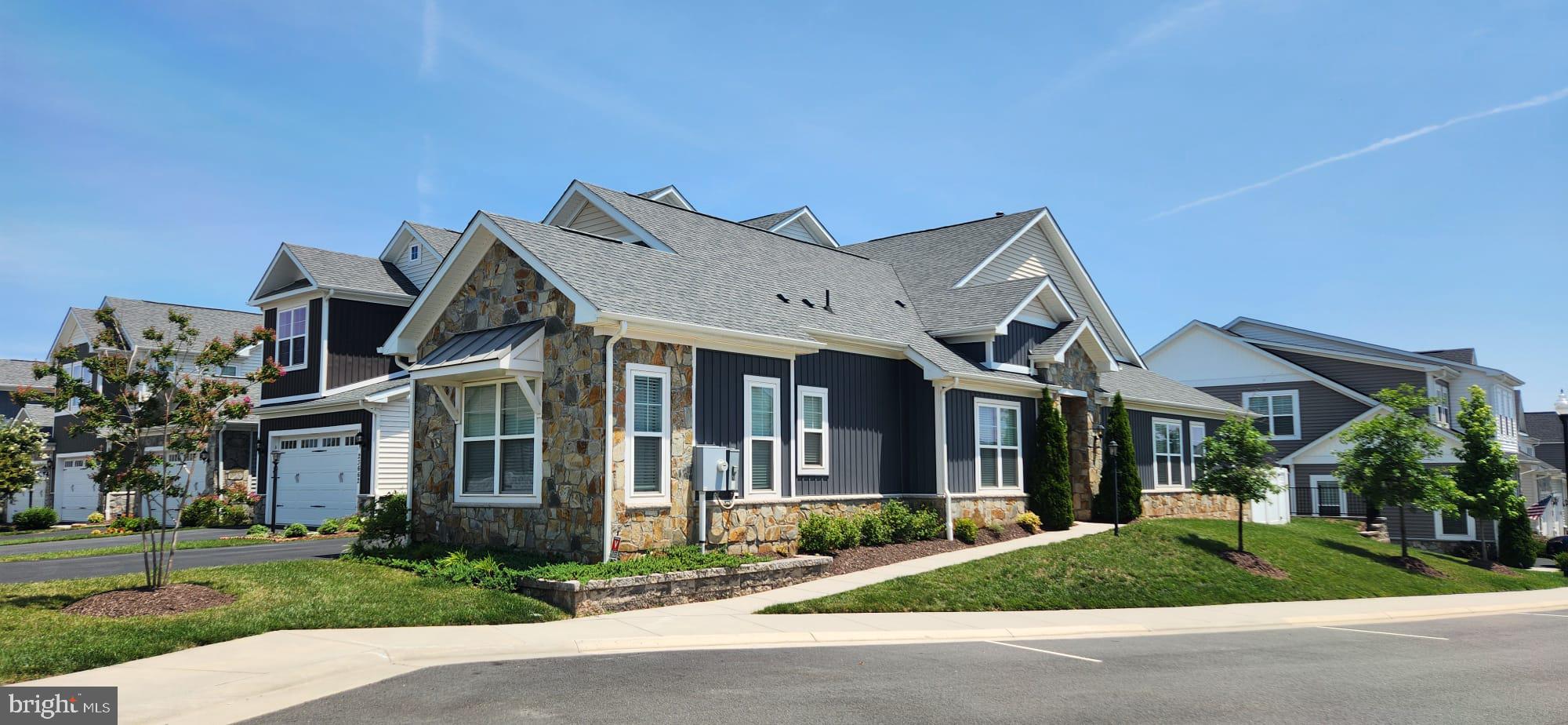 **Professional pictures and tour coming**Welcome to effortless main-level living in Birchwood at Brambleton, one of the most sought-after 55+ active adult communities in Ashburn. This impeccable end-unit Potomac model, built by Winchester Homes in 2020, offers a thoughtfully designed layout with three bedrooms conveniently located on the main level, a spacious upper-level loft, and beautiful indoor and outdoor living spaces.The elegant primary suite features a tray ceiling with crown molding, a generous walk-in closet, and a private bath with a double quartz vanity and frameless glass shower with dual showerheads. Two additional main-level bedrooms provide comfortable space for guests, a home office, or hobbies.At the heart of the home, the gourmet kitchen showcases stainless steel appliances, quartz countertops, soft-close cabinetry, a stylish backsplash, a large center island, and an impressive pantry. The kitchen opens to the inviting great room, where a tray ceiling with crown molding, a gas fireplace and a sound system create a warm and welcoming gathering space.Upstairs, the versatile loft offers endless possibilities as a media room, fitness area, office, craft space, or additional retreat. The two-car garage is complemented by an extra-large driveway with room to accommodate up to four additional vehicles, offering exceptional parking for residents and guests.Outside, enjoy a fully fenced backyard featuring a low-maintenance Trex deck and stone patio... perfect for morning coffee, outdoor dining, or relaxing with friends and family. Beautifully maintained and truly move-in ready, this exceptional Birchwood at Brambleton end-unit townhome is ready for its next chapter!