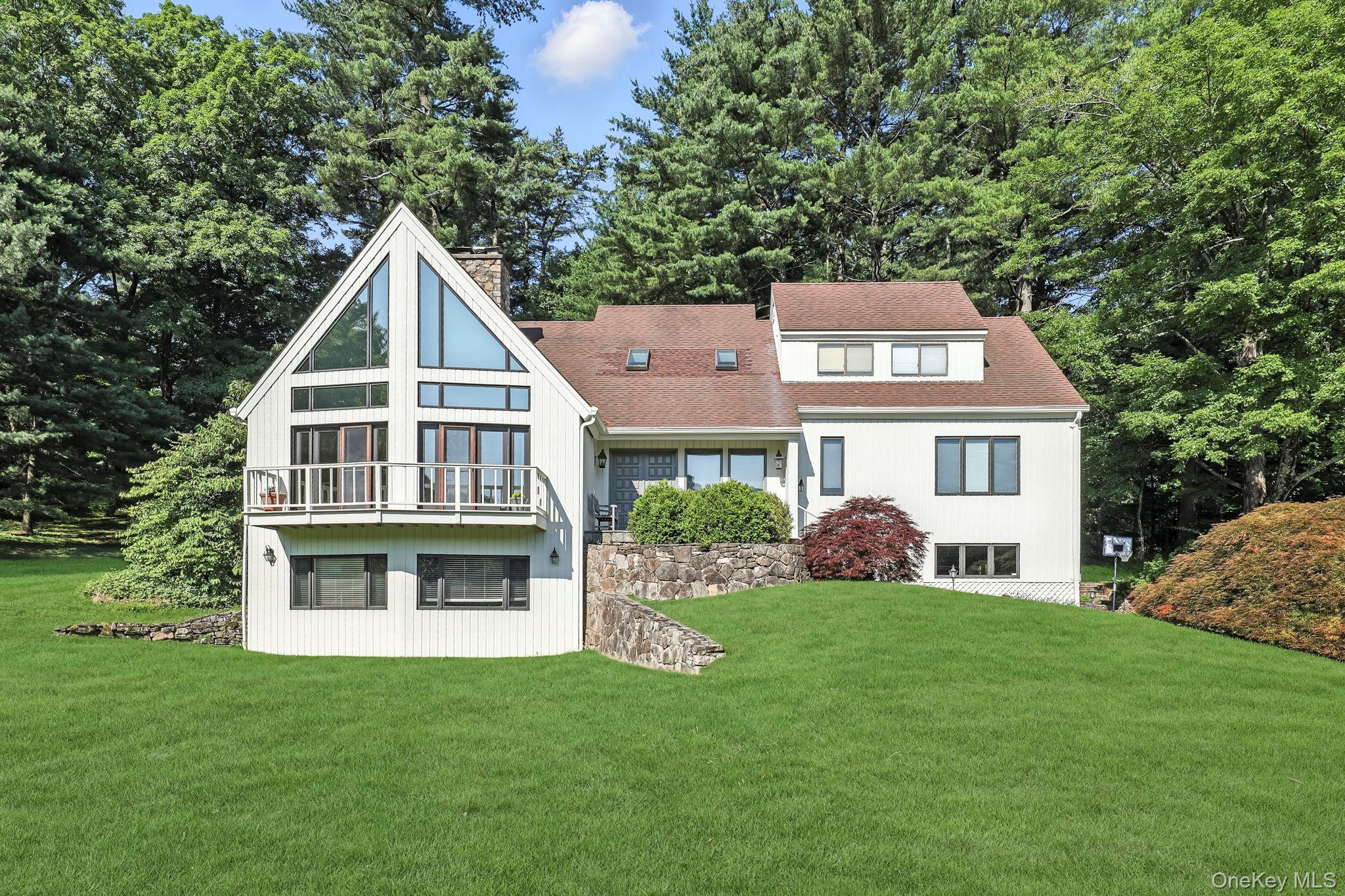Welcome to this sophisticated  4-bedroom, 3.5-bath contemporary residence, perfectly designed for today’s lifestyle with a seamless blend of modern style and functional comfort. Set on a gracious property, this home offers open, luminous living spaces flooded with natural light and thoughtful architectural detail throughout. At the heart of the home, a beautifully appointed kitchen opens to a spacious family room—ideal for relaxed gatherings and everyday living. The formal living room is a true standout, featuring near wall-to-wall windows that frame the surrounding landscape and bathe the room in sunlight. A formal dining room provides a refined setting for entertaining, while the flowing layout ensures effortless movement between spaces. The coveted main-floor primary suite offers privacy and ease, with serene views and a spa-like en-suite bath. Upstairs, three additional bedrooms provide comfort and flexibility for guests, family, or work-from-home needs. Beyond the home’s design, the location truly shines—just minutes from town, Metro-North train service, top-rated local schools, and the convenience of Whole Foods Market. Whether you're commuting, shopping, dining, or enjoying the community, everything you need is close at hand. With expansive windows, sunlit interiors, multiple living and dining areas, and a prime layout designed for both entertaining and retreat, this home offers the best of contemporary living in a timeless and highly convenient setting.