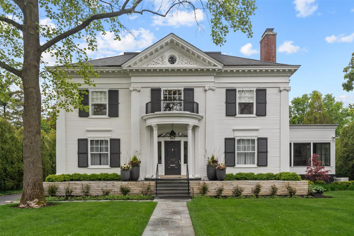 Historical Character meets Elegant Modern Living!   Experience the best of Kenilworth in this perfectly located historic home one block to the beach, schools, town, and trains. Originally built in 1896 by renowned architect Franklin Pierce Burnham, it was completely gutted and reborn in 2022 as a stunning showcase of customized modern design while maintaining its classic charm. As you enter through the original facade, the elegant staircase and vintage French oak floors welcome and guide you through the open floor plan. Once inside, you'll find the formal dining and living rooms. Custom steel and glass cabinets lead the way to the heart of the home. The open floor plan of the kitchen, breakfast and family rooms spans over 1500 sq. ft., and were perfectly designed for daily life and entertaining. A Roll & Hill pendant light hangs over the beautiful 14 ft. Paonnazzo marble island in the kitchen, which includes custom cabinetry, high-end Subzero and Wolf appliances, and a Galley workstation to keep the main kitchen area free of clutter. Floor to ceiling windows make up the entire back of the home, filling the space with natural light and offering views of the meticulously landscaped backyard. On the second floor, you will find the first-class primary suite, with an opulent spa-like ensuite bath featuring a glass-enclosed shower, soaking tub, and dual vanity. A pair of luxurious, expansive walk-in closets with built-in shelves provide ample storage space. Two additional oversized ensuite bedrooms are joined by a lounge area that can be closed off with sliding doors for extra privacy for work or play. Just a few steps up the open staircase, the third floor boasts two more bedrooms and another bathroom with dual vanity. The lower level has something for everyone: a spacious family room, game room, media room perfect for movie nights, gym, 500+ bottle wine cellar, an additional bathroom, and plenty of storage. Outside, the impressive covered patio acts as a cohesive extension of the home with a large sitting area, complete with a fireplace and ceiling heaters to allow for exceptional indoor/outdoor living year-round. The backyard also has a kitchen area with a barbecue and pizza oven, ideal for gatherings with family and friends. Above the heated three-car garage is a bedroom/office plus bathroom - use it for a private workspace, extended visitors, or however else you see fit. No details were overlooked when renovating this home to maintain its timeless elegance with modern comfort. Only the finest materials were used, with several custom pieces to create the perfect fit. A Control4 home automation system has also been installed for the ultimate peace of mind. You don't want to miss out on this one