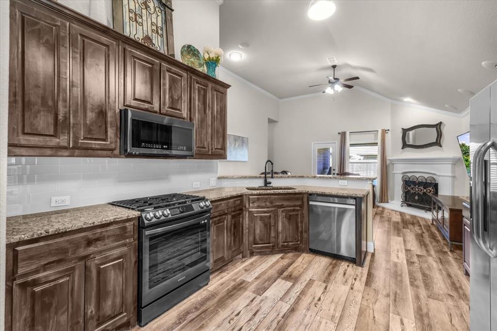 Welcome to this charming modern farmhouse, one-story brick home situated on a quiet street in a friendly Fort Worth neighborhood! A shaded front porch welcomes you inside to sun-filled, open living under a vaulted ceiling with crown molding and a cozy fireplace. The granite kitchen overlooks the family room and boasts subway tile backsplash, rich cabinetry, a gas range, bar counter, and a bright breakfast nook. The private primary suite impresses with rustic barn doors, dual vanities, a soaking tub, and a separate tiled shower! A dedicated laundry room and two-car garage keep life organized. Out back, an extended covered patio surveys a level, fully fenced yard—perfect for play, pets, and grilling. Step out to miles of neighborhood walking trails or head over to Marine Creek Lake for fishing, paddling, and wakeboarding. All of this just 10 minutes to the Stockyards and 15 minutes to Downtown Fort Worth, with schools and everyday conveniences close by. This neighborhood is also known for his lively community events and is ready to welcome you home!