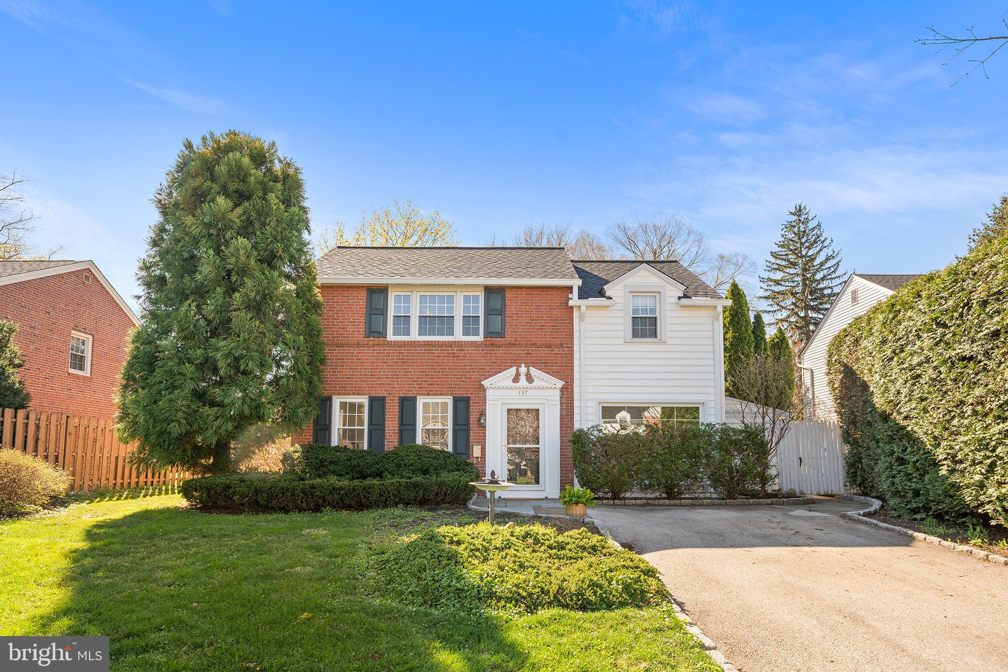 Tucked into one of Bryn Mawr's most beloved neighborhoods, this timeless brick colonial in Conestoga Village offers the best of Main Line living, walk to Clem Macrone Park, commuter rail, and Bryn Mawr's thriving restaurant and shopping scene, all within the award-winning Radnor Township School District. Lovingly cared for by the same owner for over 40 years, this home has been thoughtfully updated and expanded, with a brand-new roof just installed and a freshly painted interior; it is truly move-in ready. Step inside and feel it immediately; natural light pours through every room, casting a warm, welcoming glow that sets the tone for the entire home. The bright family room and dining area invite you in, effortlessly flowing from one space to the next. A convenient side entrance opens into a practical drop zone, perfectly suited for coming and going, with a stylish powder room off the hall for guests. Steps away, a striking wet bar adds a sophisticated and unexpected touch, wonderfully suited for entertaining without missing a beat. The converted garage adds a generous flex space that adapts to whatever your lifestyle demands, home office, fitness room, playroom, or creative studio, a rare bonus that buyers on the Main Line will immediately appreciate. The heart of the home is the spectacular rear addition. A sun-drenched, open-concept kitchen and great room made for the way people live today, crowned by soaring ceilings that make the space feel truly grand. Rich wood cabinetry, gleaming granite countertops, and an oversized island with seating create a space that is as beautiful as it is functional. A cozy gas fireplace anchors the great room, adding warmth and ambiance whether you are hosting a crowd or enjoying a quiet evening in. Enjoy meals together in the generous eat-in area and savor the seamless flow of a room designed for both everyday moments and gracious hosting. Step outside through the back door to a private patio enveloped by mature privacy landscaping and a lush, expansive yard complete with professionally installed drainage and a large storage shed, beautiful, functional, and worry-free for years to come. Upstairs, the serene primary suite is joined by two additional well-proportioned bedrooms and a beautifully remodeled full bath. The finished lower level delivers exceptional bonus square footage with a second full bath, an open living area perfect for a media room, and dedicated laundry space; every inch earns its keep. Conestoga Village is more than a neighborhood; it is a community full of life, where tree-lined streets, friendly faces, and a true sense of belonging await just outside your front door. And with Garrett Hill's beloved annual Fourth of July parade around the corner, you'll feel at home from the very first day. This is not just a house; it is the one you will never want to leave. Schedule your private tour today!