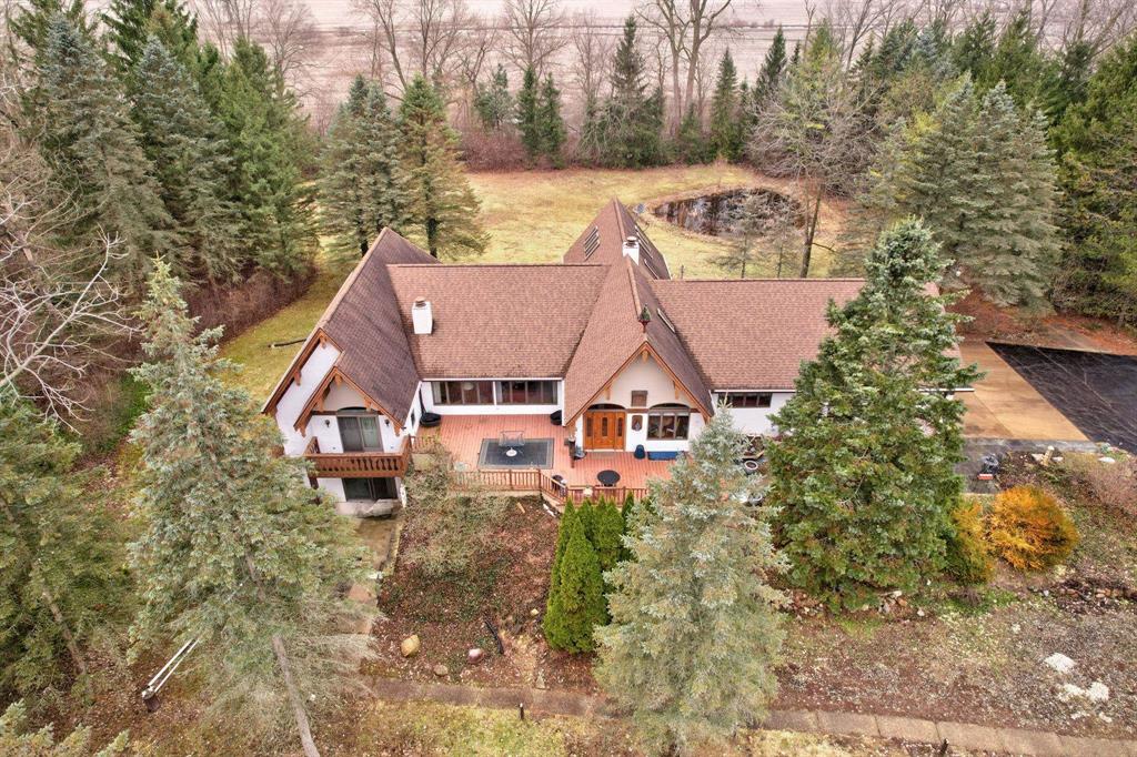 This extraordinary residence offers an unparalleled blend of luxury and country tranquility that will captivate your heart from the moment you arrive. Nestled within a breathtaking setting featuring two serene ponds, this four to five-bedroom, six-bathroom home delivers over three thousand square feet of thoughtfully designed living space. The primary suite serves as your personal retreat, complete with a cozy fireplace and generous walk-in closet. Here's something you don't see every day-every bedroom boasts its own full bathroom, providing convenience and privacy for all residents. Access the expansive deck from any main floor bedroom, where peaceful views await. The finished basement takes versatility to new heights with a complete one-bedroom apartment, perfect for guests or potential rental income. Outside, a spacious thirty-two by twenty-four pole barn provides ample storage for vehicles, equipment, or workshop dreams. Whether you're sipping morning coffee overlooking the ponds or hosting gatherings on the deck, this property promises a lifestyle most only dream about. Schedule your private tour today and discover what makes this home truly exceptional.