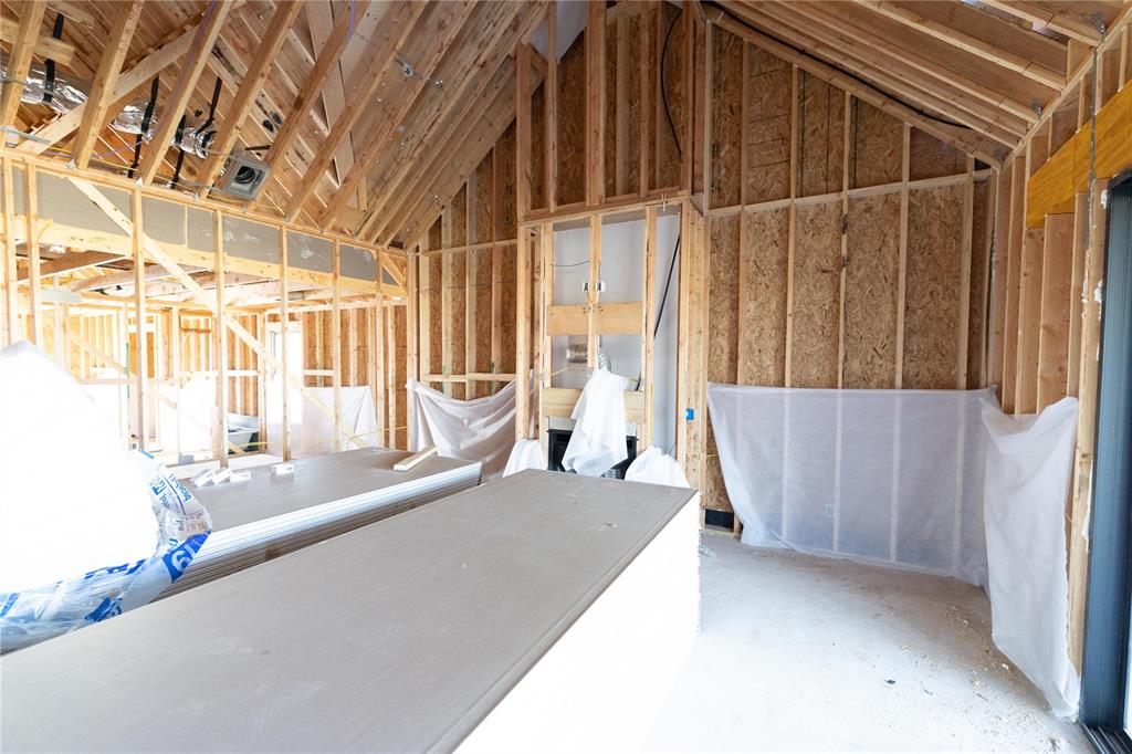 This Wesley Bonus Room floor plan includes 3,630 Sqft of total living space, which features 3,285 Sqft of indoor living space and 345 Sqft of outdoor living space. There is also a 590 Sqft, three-car garage with an in-ground storm shelter installed! This desirable home offers 5 bedrooms, 3 full bathrooms, covered patios, a large bonus room, a powder room, and a utility room featuring a utility sink. The great room supports an immaculate cathedral ceiling with a crows feet detail and a ceiling fan, a luxurious 3-panel sliding door with a 4’ back patio extension, wood-look tile, rocker switches throughout, Cat6 wiring, eggshell paint, and a center gas fireplace surrounded by our exquisite stacked stone detail. The upscale kitchen boasts stunning pendant lighting, stainless steel appliances including double ovens and a 5-burner cooktop, 3 CM countertops, vogue tile backsplash, well-crafted cabinets to the ceiling with cabinet hardware throughout and under cabinet lighting, decorative end panels, a separate walk-in pantry, and a large center island that holds a roomy sink, a dishwasher, and a trash can pullout. The primary suite provides a sloped ceiling detail, a ceiling fan, a plush carpet finish, and windows. Attached is the main bath, which has a bat-winged vanity with framed mirrors, 3 CM countertops, a large European walk-in shower, a private water closet with an elongated toilet, a free-standing tub, and a HUGE walk-in closet! The covered outdoor living area welcomes a wood-burning fireplace, a gas line for your grill, and a handy TV hookup. Other included features for this elegant home include our healthy home technology, an air filtration system, a tankless water heater, double glazed vinyl low E windows with argon, R-44 and R-15 insulation, a fresh air ventilation system, and so much more!