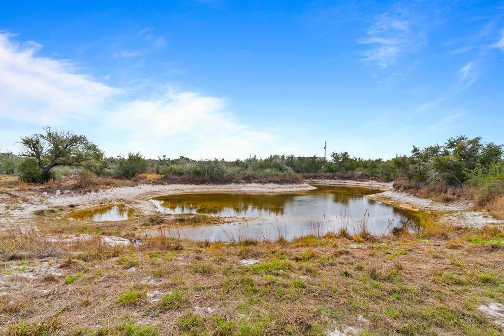 New Price!!! $220,000 Cleared and ready for your plans. Almost 3.5 acres. Discover the perfect balance of seclusion and convenience in this estate-style neighborhood between Rockport and Aransas Pass. This spacious lot is adorned with majestic oak trees, abundant wildlife, and two picturesque ponds. While just a quick drive to the Bypass for easy commuting, the setting feels private and serene&mdash;yet you're still only minutes from downtown Rockport and the Cove Harbor Boat Ramp. Create your own private oasis in this desirable community&mdash;all at an exceptional value. Don't miss the opportunity to see this gem today, buildable lots are running out. Bring your Plans and your vision and make this yours.