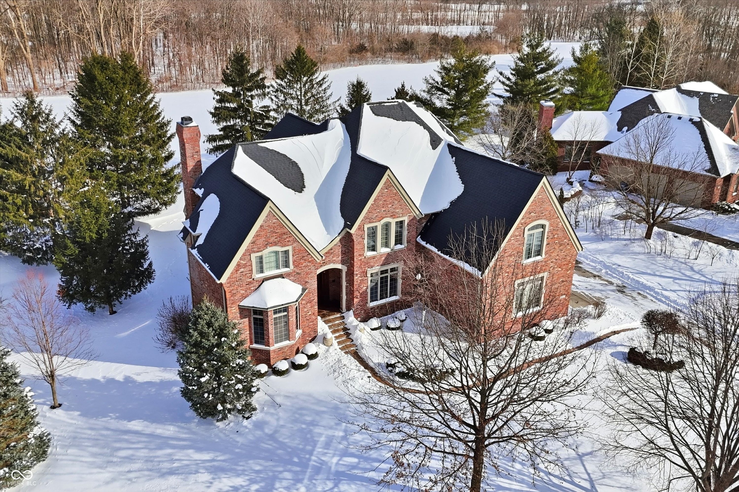 A STEPHEN GOLDBERG designed HAMILTON PROPER masterpiece just hit the market! As you drive through the GATED ENTRANCE you will notice the Hawthorns golf course on each side - COUNTRY CLUB LIVING at its finest! Offering 7400+ sq ft, this custom estate offers BREATHTAKING GOLF COURSE VIEWS, 5 bedrooms, 6 baths, finished WALKOUT BASEMENT, 3 fireplaces, 10' ceilings on main & upper levels, plentiful storage, 4 CAR GARAGE & an incredible outdoor living space! The main level features a 19' tall entryway, stately office w/wood paneling, custom built-ins & glass doors, a 15' long elegant dining rm w/access to the kitchen through a butlers pantry, an inviting great rm w/14' ceiling, wall of windows & beautiful gas fireplace, a hearth rm w/gas fireplace & open to a expansive chef's kitchen w/WI pantry, high-end appliances (many BOSCHE), a 13' center island & breakfast nook w/access to a cozy sunroom w/18' ceiling & leads to a covered patio w/retractable screens, fireplace & TV! The main level also includes TWO half bathrooms + a mud room w/lockers & convenient work station! The upper level features a loft, 19x18' owners suite w/11' ceiling, a stunning spa bath w/dual vanities, jetted tub, WI shower w/dual heads, double tray ceiling & 14x11' WI closet w/center island! The upper level also boasts 3 oversized secondary bedrooms, each w/10' ceilings, WI closets & access to a full bathroom. The WALKOUT basement was built to entertain, offering a family rm w/built-ins, fully equipped bar, wine closet, card/game space, billiards rm (leads to an outdoor patio), 20x15' exercise rm w/10' ceilings (perfect space for a golf simulator), 5th bedroom, full bath & 23' utility/storage rm! The main level outdoor living space features a 27x16' patio w/grilling station & sink! A short walk/bike ride to the Hawthorns Country Club & close to shopping, dining, schools, parks, the interstate & more! Roof & both HVAC units replaced within last few years.