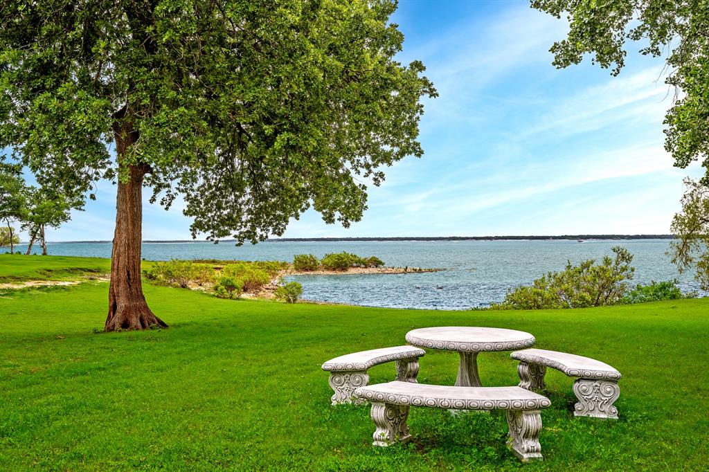 Experience peaceful lakefront living in this beautifully updated 3-bedroom, 2.5-bath home with stunning panoramic lake views and direct walk-down access to the water. Designed for comfort and relaxation, this home features an open-concept living area filled with natural light and breathtaking views from nearly every room along the lake-facing side of the home.The spacious master suite is a private retreat, complete with beautiful granite countertops and serene views that make every morning feel like a getaway. Downstairs has been thoughtfully updated, offering modern finishes and a fresh, inviting feel throughout. Upstairs 2 bedrooms, 1 bath, and extra room, game room or office.Step outside to the covered back deck, where the soothing sights and sounds of the water create the perfect place to unwind. Whether enjoying your morning coffee, entertaining guests, or simply spending the day watching the lake, this outdoor space is truly the heart of the home.A rare opportunity to own a lakeview, lakefront property that combines comfort, style, and the kind of views you never want to leave.