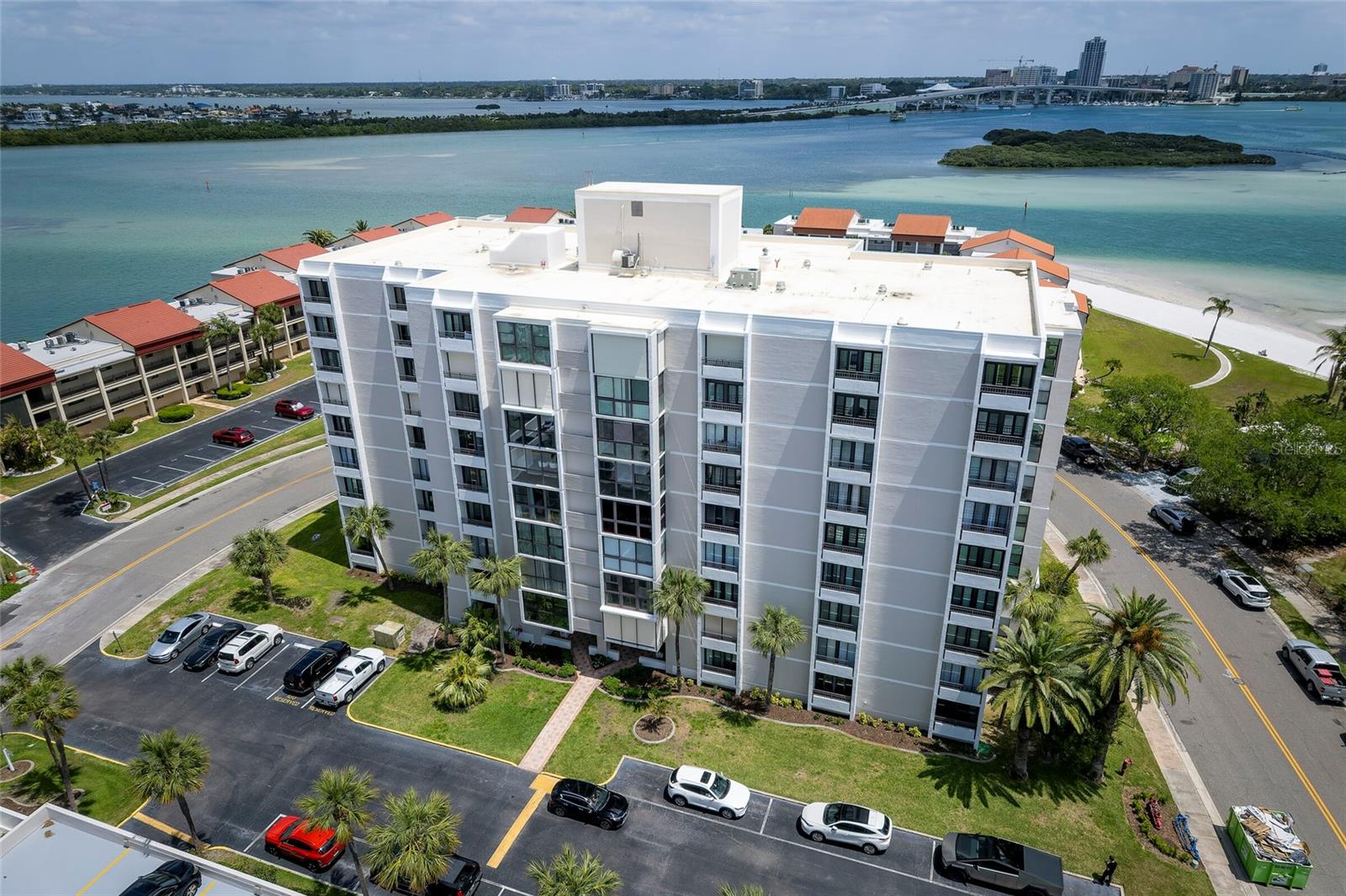Experience elevated coastal living in this stunning corner unit on Clearwater Beach, where sweeping water views can be enjoyed from nearly every room. Situated on the quieter south end of this award-winning shoreline, this residence offers a rare blend of privacy and resort-style amenities.Residents enjoy access to a private stretch of sandy beach, three heated pools, a spa, fire pit, and beautifully refreshed outdoor gathering spaces with grilling areas—perfect for entertaining or unwinding after a day by the water. The unit includes upper garage parking, in-unit laundry, and secure building access.Inside, the living space showcases expansive intra coastal views, while each bedroom features its own private balcony—ideal for morning coffee, coastal breezes, and spotting dolphins offshore. The updated kitchen brings a modern touch, and the top-floor location enhances both tranquility and exclusivity.Recent building upgrades include a new roof, hurricane protection for the windows, and completed milestone inspections, offering added peace of mind. Just a short stroll from local dining, shopping, and entertainment, this location allows you to enjoy the best of beach living without needing a car. Tampa International Airport and downtown St. Petersburg are both within an easy drive. Whether you're searching for a primary residence, seasonal escape, or income-producing property, this unit offers an exceptional combination of comfort, convenience, and coastal charm.HOA covers water, sewer, trash, cable, internet, exterior maintenance, security, private beach access, pools, and shared outdoor amenities. Fully furnished. Just bring a body and some cloths and your ready to go.