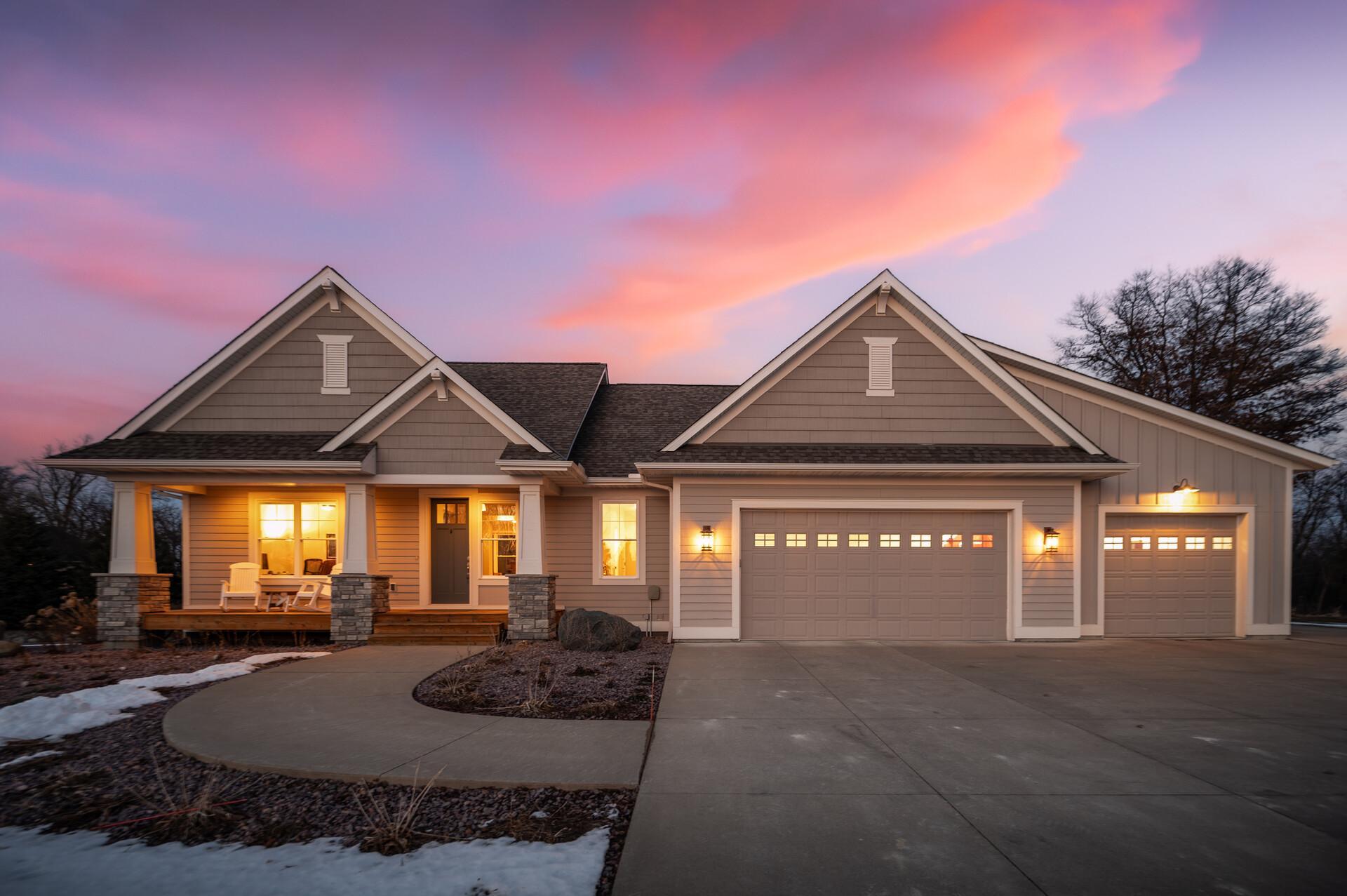 This exceptional 5-bedroom, 4-bathroom custom modern Craftsman offers an extraordinary blend of refined design, expansive living spaces, and breathtaking natural surroundings on 2.81 private acres of restored prairie in the Lakeville School District. With no neighbors behind the home and a scenic wooded backdrop, the setting provides remarkable privacy and serene, uninterrupted views.Thoughtfully designed and built in 2015, the home showcases intentional craftsmanship and high-end finishes throughout. The light-filled open-concept main level creates a seamless flow between living, dining, and kitchen spaces, ideal for both everyday living and entertaining. At the heart of the home, the stunning kitchen features elegant quartz counters, a spacious center island with seating, and premium stainless steel appliances. The adjoining dining area and inviting living room are framed by expansive windows that bring the surrounding landscape indoors.The private primary suite offers a luxurious retreat with a spacious walk-in closet and a spa-inspired ensuite. A second main-level bedroom provides flexibility for guests or a home office, while the walkout lower level expands the living space with a large family room and three additional bedrooms.Car enthusiasts and hobbyists will appreciate the remarkable 1,308 sqft custom garage designed to accommodate up to seven vehicles with lift-ready bays, climate control, and premium utility features. The property also includes a fully planned 2,000 sqft future shop site with infrastructure already in place, offering an exceptional opportunity for expanded workspace, storage, or a custom outbuilding with potential living space above.Combining luxury craftsmanship, expansive space, and thoughtfully planned future potential, this one-of-a-kind property offers a rare opportunity to enjoy privacy, flexibility, and refined living in an extraordinary natural setting.