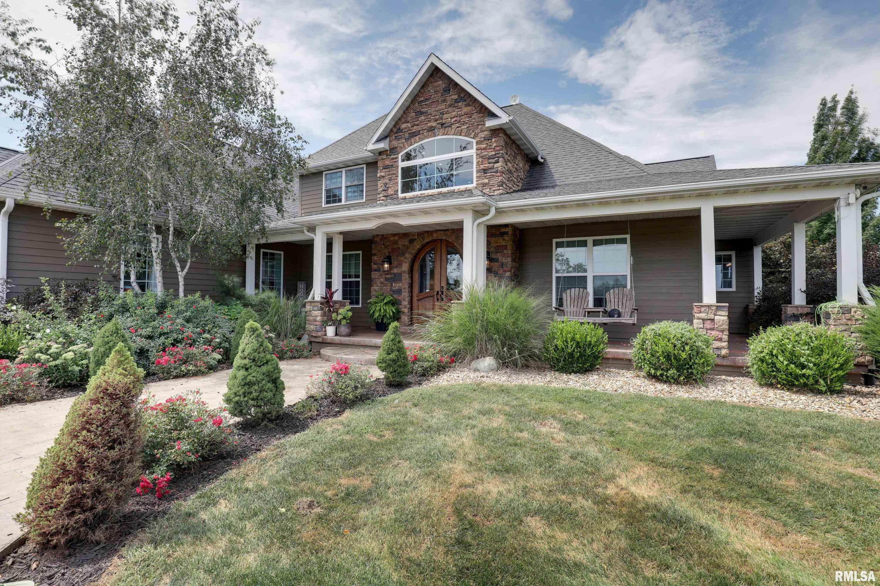 Welcome to your private sanctuary in sought-after Palmyra, MO! This magnificent 5 bedroom, 3 full and 2 half bath home offers over 6,400 sq ft of luxury living with the perfect blend of elegance and comfort. Arrive by a long private drive to a stately covered porch and beautifully landscaped grounds. Inside, a grand 2-story foyer sets the tone with a formal sitting room, expansive living space with soaring windows, and a cozy fireplace. The Tuscan-inspired kitchen is a chef’s delight, featuring stone countertops, custom range hood, stainless appliances, a central island, and walk-in pantry.  The master suite (14x25) lives like a private retreat with a spa-like bath boasting dual vanities, whirlpool tub, massive tiled shower, and an 8x17 walk-in close, while the upstairs offers 3 additional bedrooms, including one en suite, a shared full bath, and a versatile recreation room. The walkout lower level features a spacious family room and an additional bedroom with private entry—ideal for guests or multigenerational living as well as a convenient finished 4th garage currently being used as a home gym.   But the real magic happens outside! Set on 8.1 acres with a private lake, the outdoor spaces impress with nearly 1,200 sq ft of covered porch, and a lower-level stone patio with a  fireplace, an outdoor kitchen, and a pizza oven. An additional 5 acres is available for purchase as well. Don’t miss this rare chance to own your dream home where every day feels like a vacation!