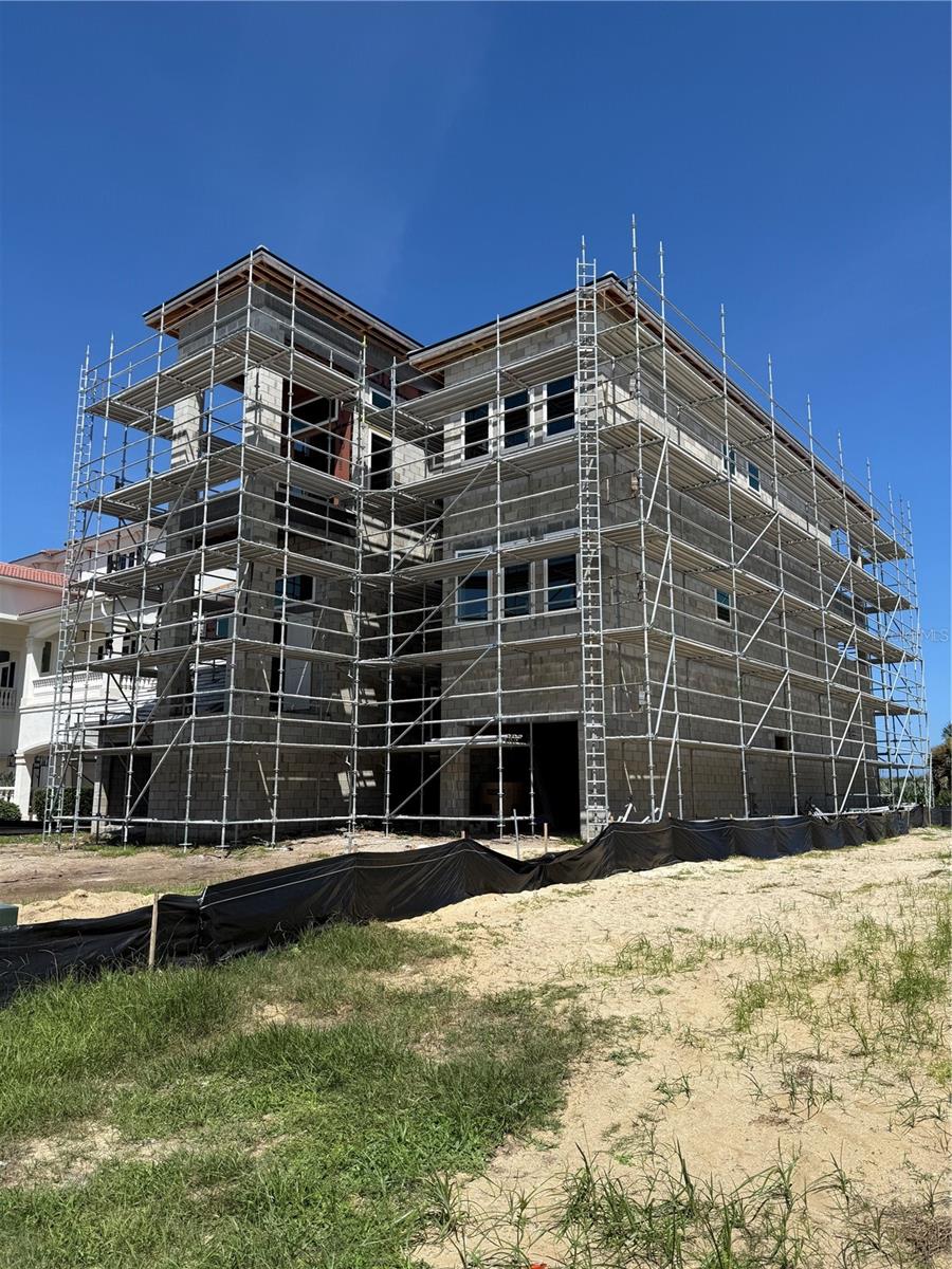 Under Construction. "WHERE SUCCESS MEETS THE SEA" Welcome to a truly exceptional oceanfront estate, "The Sea Turtle House" one of 2 homes currently being offered in the "Ocean Ridge Collection". Both are nearing a completion date sometime in early 2027. This extraordinary oceanfront residence was introduced to the market during construction-not after completion. Building a custom oceanfront estate of this caliber in Ocean Hammock is an approximately 2 1/2 year process. The reported market time therefore reflects the period in which the residence was being created from a vacant lot. For the buyer who wants NEW Florida Oceanfront Construction without starting a multi-year build from the ground up, this is your opportunity! Nestled within the elite gated community of Ocean Hammock, this 6 bedroom, 6 full bathrooms and 2 half baths will accommodate any living situation with the privacy for all. Spectacular VIEWS OF THE ATLANTIC OCEAN for everybody! Pristine beaches merging luxury with tranquility. In your new dream home you'll also enjoy sunset views from the upper floors on the front of the house. Experience serene mornings with breathtaking Atlantic sunrises, unwind with picturesque sunsets in this unique coastal community. 6,623 square feet of artfully designed living space, Exceptional craftsmanship and refined architectural elegance. The main living space is expertly crafted to showcase panoramic ocean vistas, providing a peaceful and picturesque backdrop for relaxation and entertaining. An elevator ensures effortless access to all levels, while a community beach walkover allows for direct beach enjoyment. The outdoor retreat features a Lavish 13ftX24ft "Saltwater Super Pool" with spa/hot tub and complete summer kitchen. A full bathroom accessible from the pool area enhances the outdoor living experience. The dedicated home theater is prewired for 15 speakers. Additional practical features include 2 laundry rooms, one is located on the 3rd floor by all the bedrooms,the other laundry room is on the 1st floor for pool and beach towels, plus a full pet washing station, further enhancing the home's functionality. Whether basking in the private pool/ hot tub, entertaining in the outdoor space this home is exquisite! The community boasts one of "Florida's Top Oceanfront Golf Courses". A Jack Nicklaus Signature Designed Oceanfront Course winds along six holes overlooking the Atlantic Ocean-the most in Florida. The course's final four holes, nicknamed "The Bear Claw" by Jack Nicklaus himself. gives every golfer a totally unique experience. The "Fantasy Pool Complex" at the Hammock Beach Golf Resort & Spa features a lazy river overlooking the Atlantic Ocean. As a resident, you'll enjoy membership opportunities at one of Florida's most desirable oceanfront clubs featuring 2 championship golf courses, resort style pool, oceanfront dining, tennis courts, fitness facility and many other social experiences for friends and family. Wake up each day to the sound of rolling waves and walk the pristine beach just outside your door. This is way more than a home-it's a destination, a sanctuary and a legacy property designed to be enjoyed and cherished for generations. LUXURY, PRIVACY & EXCLUSIVITY. Oceanfront Living at its Finest. Designed for those who have worked hard and now desire the rewards of an extraordinary lifestyle. ***Some features are optional***Select photographs have been virtually staged and/or digitally enhanced for illustrative purposes.**