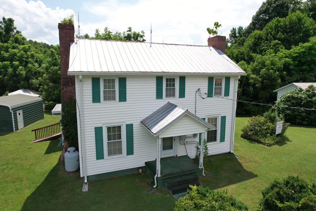 Historic 3-Bedroom, 1-Bath Farmhouse on 55 Acres. Step into history with this unique opportunity to own the former homeplace of Floyd Allen, a figure tied to the area's storied past. This 3-bedroom, 1-bath farmhouse offers 2,068 sq ft of classic living space and sits on 55 acres of beautiful, versatile land.The home features beautiful oak hardwood floors, spacious living areas, and timeless farmhouse charm. The main level includes a kitchen, living room, primary bedroom, full bath, and laundry area. Upstairs, you'll find two additional bedrooms and a bonus room perfect for storage, an office, or a craft space. Notably, the hand-carved stair railing, crafted by Mr. Allen himself, showcases the craftsmanship and character of this historic home. Outside, the property includes a metal garage, multiple sheds, and two additional buildings that would be ideal for storage, workshops, or restoration projects. One of these buildings formerly operated as a produce store, a reminder of the property's days as a fruit orchard. Start exploring the land and you'll quickly see the potential. The 55 acres offer multiple building sites with development possibilities , or you can enjoy it as your own private recreational retreat. The land features mature timber, natural springs, small streams, and a peaceful pond. Several trails throughout the property are perfect for hiking, ATV riding, and the abundant wildlife makes it ideal for hunting or nature watching. Whether you're seeking a quiet homestead, a hunting and recreation property, or a future development site, this property delivers. Conveniently located just minutes from I-77, US-52, and the Blue Ridge Parkway.