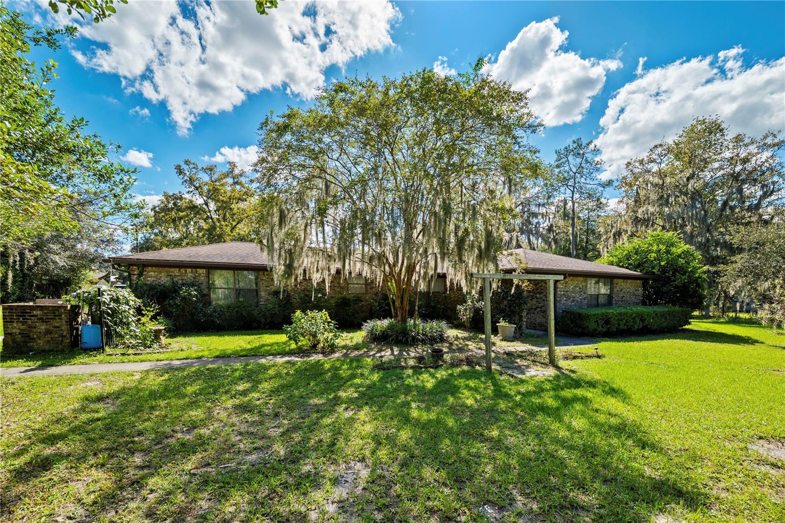 **3 ACRES**UPDATED**FULLY FENCED** This immaculately maintained ALL BRICK 4 bed/3 bath, 2,275sqft home offers the peace and quiet of country living with NO HOA! Sitting HIGH AND DRY at the crest of a hill on 3 ACRES of fully fenced property with mature landscaping, it features a 2018 roof, 2024 HVAC, and a NEWER WATER HEATER (2025). This LARGE HOME is excellent for entertaining, boasting a dedicated dining area, breakfast nook, screened-in patio, and tastefully updated bathrooms. Experience breathtaking sunrises, sunsets, and starry nights in a birdwatcher's paradise with plenty of room for gardening, animals, horses, or a pool. Enjoy ultimate flexibility with a carport, a garage ready to convert to an ADU/MOTHER IN LAW SUITE, an insulated outbuilding/SHE-SHED, and a separate GARAGE in the back ideal for hobbies or a home business. Located just minutes from Black Creek, Jennings State Forest, shopping, and Ascension St Vincent’s Hospital! Don’t miss this incredible deal!