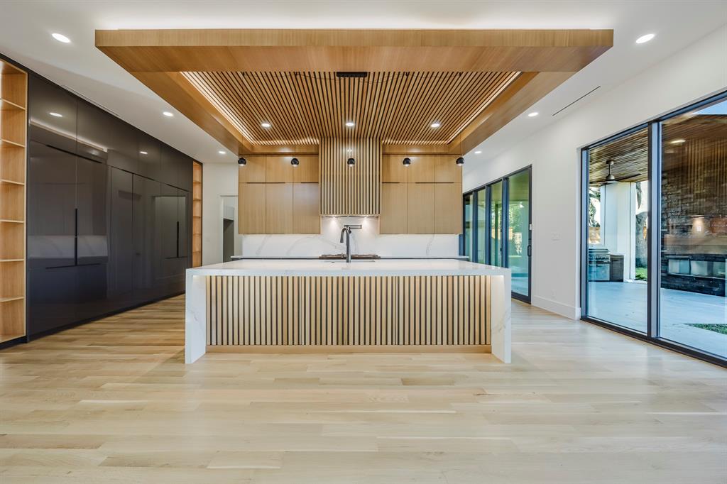 Nestled in prestigious Preston Hollow, this stunning contemporary residence fuses modern elegance with a highly functional layout—offering rare access to Dallas’s coveted private school corridor.The open-concept living space is perfect for entertaining, while the downstairs study with custom cabinetry creates an ideal home office or library.The primary suite showcases peaceful views of the backyard with room for a future pool, creating a true private retreat. A first-floor guest suite adds convenience and flexibility for visitors or multigenerational living.Wine enthusiasts will appreciate the sleek, glass-enclosed wine room—an impressive showcase for your collection. Upstairs you’ll find three ensuite bedrooms, a spacious game room, and an open loft.Additional highlights include a rare 3-car garage and elevated prewiring throughout: audio, video, security, and motorized window treatments all centralized for the buyers convenience for a future home automation. Three garage outlets are wired for EV charging, the patio is wired for future ceiling heaters, and is prepped for future patio screens.This is an extraordinary modern home in one of Dallas’s premier neighborhoods. Experience design, function, and location at its finest. Explore everything this masterpiece has to offer!ASK ME ABOUT THE RATE BUY DOWN!