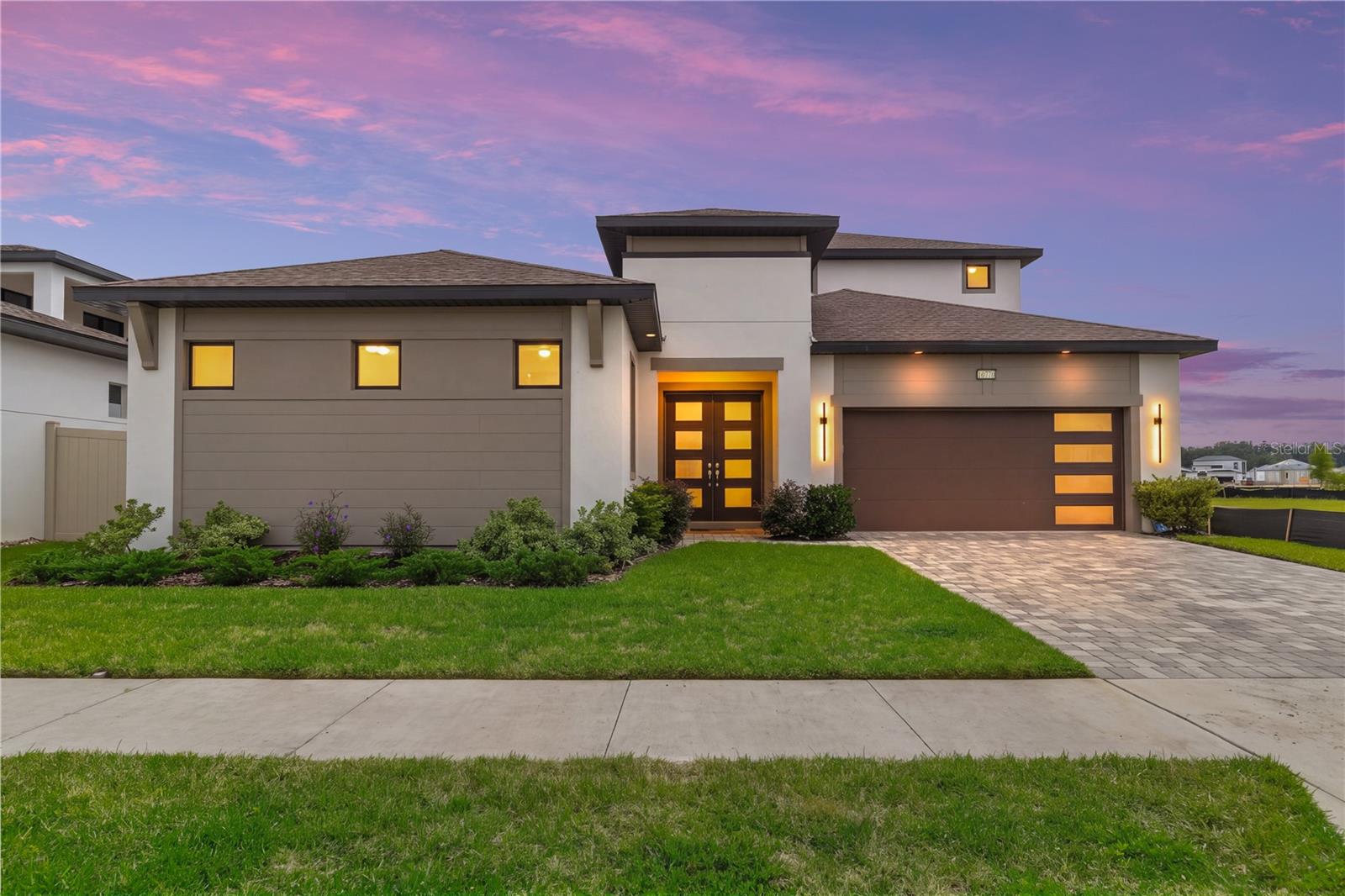 An exceptional blend of modern design, private poolside living, and an IN LAW SUITE with a PRIVATE ENTRANCE awaits at 10770 Torchwood Sea Way in Eagles Cove at Mirada. Completed in 2025, this beautifully appointed DRB Homes Osprey 3 residence offers 3,653 square feet of heated living space and 4,737 total square feet, with six bedrooms, four full bathrooms, one half bathroom, and a two car garage. Extensive builder upgrades and custom window treatments enhance a versatile layout designed for comfortable daily living and memorable entertaining. The Modern exterior elevation and upgraded privacy glass double doors create an impressive arrival. Inside, decorative tray ceilings, additional windows, and expansive living spaces give the home an inviting architectural presence. The open kitchen, dining, and living areas keep gatherings connected, while a large center opening sliding glass door brings the courtyard pool retreat into view. The kitchen features Rigel granite countertops with a straight edge, a generous island, gas cooking, and an installed pot filler. A standout feature is the sixth bedroom, configured as an IN LAW SUITE with its own PRIVATE ENTRANCE, bedroom, living room, and full bathroom. Sliding glass doors overlook the pool, creating an inviting retreat for extended family or visiting guests who appreciate their own space. The first floor primary suite offers a luxurious place to unwind. Its upgraded wet bath features an oversized shower area, enlarged glass enclosure, two independently controlled shower heads, recessed niches, and a freestanding soaking tub. Custom fitted roller shades by Tampa Window Shades provide a coordinated finish throughout the home, with motorized shades at select living room and primary bedroom openings for added convenience. Upstairs, the spacious loft offers possibilities for a media room, game lounge, second living area, or workspace. A covered balcony extends the living space outdoors, with sliding glass access from the loft and two upstairs bedrooms. A dedicated laundry room with an installed sink adds everyday functionality. Your private HEATED SALT WATER POOL and spa create the centerpiece of the courtyard, surrounded by a screened enclosure that makes outdoor relaxation and entertaining especially inviting. Premium Pentair pool equipment and a HeatWave SuperQuiet heater enhance this outdoor retreat with quality equipment and quiet heating performance. Enjoy a refreshing swim, unwind in the spa, or gather poolside in a setting that feels like your own personal getaway. The two car garage features upgraded epoxy floor coating for a clean, polished finish. Beyond the home, Mirada’s approximately 15 acre lagoon offers a remarkable beach inspired lifestyle with clear blue water, sandy shorelines, swimming, kayaking, and paddle boarding. Waterfront bars, cabana rentals, water attractions, and community activities bring recreation and social opportunities into this distinctive lagoon community. With its IN LAW SUITE WITH A PRIVATE ENTRANCE, generous living spaces, premium finishes, HEATED SALT WATER POOL, and signature Mirada setting, this exceptional residence offers a luxurious and flexible approach to Florida living. Schedule your private showing to experience it firsthand.