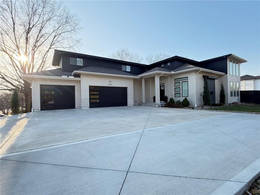 Discover this stunning open-plan 1.5-story home in Weatherby Lake, MO, just 4 years old and designed for modern, flexible living. This property features a full, separate living quarters ideal for multi-generational living, guests, or private workspace, including a bedroom, bathroom, walk-in closet, family room, dining area, recreational space, kitchen, and laundry.The main level offers true single-level living with a primary suite, dining area, great room, laundry, and office space. The gourmet kitchen is equipped with a large island, marble backsplash, double ovens, drawer microwave, and 5-burner gas cooktop, perfect for entertaining and everyday living.  Upstairs, you’ll find three additional bedrooms and nearly 900 square feet of versatile living space, ideal for a kids’ hangout, workout room, media room, or home office. Exterior highlights include an epoxy-coated garage floor, expanded driveway, patio, privacy-fenced backyard, and additional shed storage—perfect for outdoor living and organization.Recent upgrades include a secondary living area in the lower level with an added egress window, enhancing light and functionality, plantation shutters, hardwood flooring on main level and more! All appliances stay for added value and convenience!   Located in the sought-after Weatherby Lake community, residents enjoy lake life with boat access, leased and WLIC member docks, private beach, community center, tennis, pickleball and basketball courts, and multiple playgrounds.  This home is served by Hawthorne Elementary, Congress Middle School, and Park Hill High School and offers unbeatable convenience—close to shopping, Kansas City International Airport (KCI), just 20 minutes from downtown Kansas City, MO, and 15 minutes from The Legends area in Kansas.Hard to find modern new home in Weatherby Lake, MO with lake access, flexible living space, and luxury upgrades, this property delivers lifestyle, location, and value.