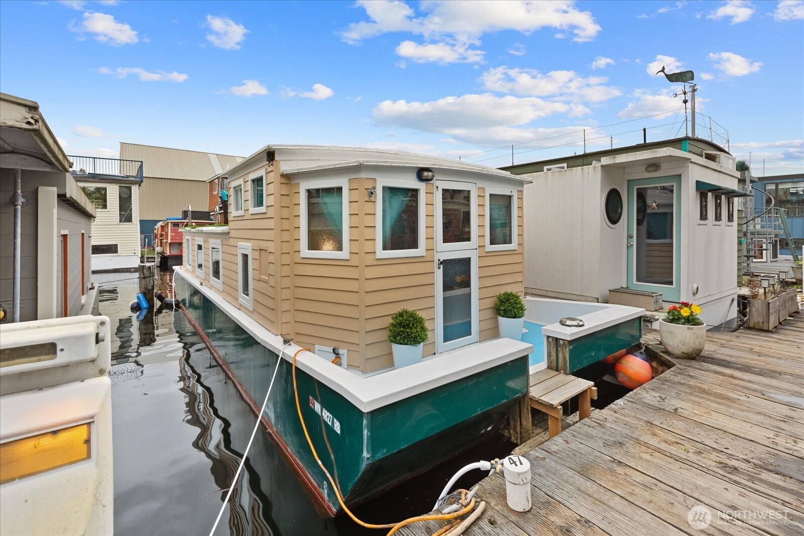 Fresh Craftsman houseboat in prime Lake Union location w/ condo-owned moorage. New exterior paint and deck refinish 4/26. Enjoy Lake and Downtown views from your private roof deck making this charmer the perfect in-City retreat.  Room for a 2nd bed and walk-in closet could double as an office.  Harwood floors, skylights, & full-size refrigerator. Great community w/ private parking, upgraded shower & laundry facilities, on-site manager, secure package delivery + storage available for rent. Located on the Burke-Gilman trail & directly next to sunny Gasworks Park & super yachts. Blocks from shops & restaurants in Wallingford, Fremont & University. Marina allows pets & rentals (30+ days), parking & mail included.  All patio furniture, floating dock and paddleboard included in sale. FOWR 756