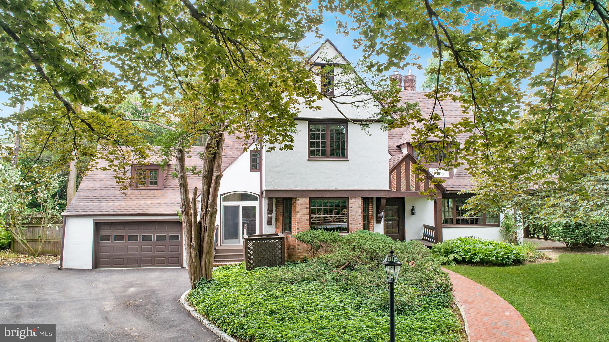 Welcome to 556 Saint Davids Avenue, an architecturally significant English Tudor nestled in the heart of prestigious Saint Davids within Radnor Township. Rich in timeless craftsmanship and thoughtfully updated, this exceptional residence showcases distinctive period architecture, premium improvements, and modern comforts in one of the Main Line's most coveted neighborhoods.A welcoming covered front porch with a built-in bench opens to a gracious center hall featuring hardwood floors and a convenient powder room. The inviting living room offers hardwood flooring, Marvin replacement windows, a gas fireplace with insert, and double doors leading to an enclosed patio overlooking extensive mature landscaping. The formal dining room is highlighted by beautiful Mercer tile flooring, Marvin replacement windows, a built-in bench, and elegant wall sconces.The beautifully updated cherry kitchen is designed for everyday living and entertaining and features stainless steel appliances, including a six burner Thermador gas range with electric convection oven, dual Monogram Advantium convection ovens, a Monogram refrigerator with interior water dispenser, Thermador warming drawer, KitchenAid dishwasher, tiled backsplash, under cabinet lighting, a built in writing desk with overhead mail station, stainless steel exhaust hood, and an Andersen sliding glass door leading outdoors.The spacious primary suite features hardwood flooring, custom built in drawers, newer Marvin replacement windows, and a spectacular English Tudor turret alcove with a faceted vaulted ceiling and three-sided windows. The adjoining walk-in closet includes an arched opening, additional built-in storage, and newer Pella replacement windows. The luxurious marble primary bath offers a jetted soaking tub, frameless glass shower, double vanity, brass fixtures, illuminated medicine cabinets, and recessed lighting. The second bedroom features newer Marvin replacement windows and an updated en suite bath, while two additional bedrooms offer hardwood flooring, generous closet space, and flexibility for family, guests, or a home office.Additional highlights include a recently replaced driveway, newer generator, an attached two car garage with inside access and a ½ HP automatic garage door opener, a partially finished basement with a Maytag washer, Kenmore dryer, and utility sink, both high velocity and conventional ducted central air conditioning systems for year round comfort, updated 200 amp electrical service, original mortised locks, solid wood doors, brass hardware throughout, and a Weil McLain WM97+ high efficiency gas boiler with an integrated tankless hot water system.Located within the award-winning Radnor Township School District, this exceptional residence is just a short walk to the Saint Davids SEPTA Regional Rail Station on the Paoli Thorndale Line, providing convenient rail service to Center City Philadelphia and beyond. Enjoy quick access to Routes 30 and 202, I-476 (Blue Route), I-76 (Schuylkill Expressway), and the Pennsylvania Turnpike. Just minutes away are the acclaimed restaurants, boutique shopping, coffee shops, and vibrant atmosphere of Downtown Wayne. Nearby Main Line Health, Bryn Mawr Hospital, Lankenau Medical Center, Penn Medicine, parks, walking trails, golf courses, and country clubs complete the outstanding Main Line lifestyle offered by this remarkable home.Don't miss our exclusive website for this home, featuring a 3D Matterport tour, Virtual Reality Walkthrough, detailed floor plan, professional photography, aerial drone neighborhood footage. Note: Some photos have been digitally enhanced