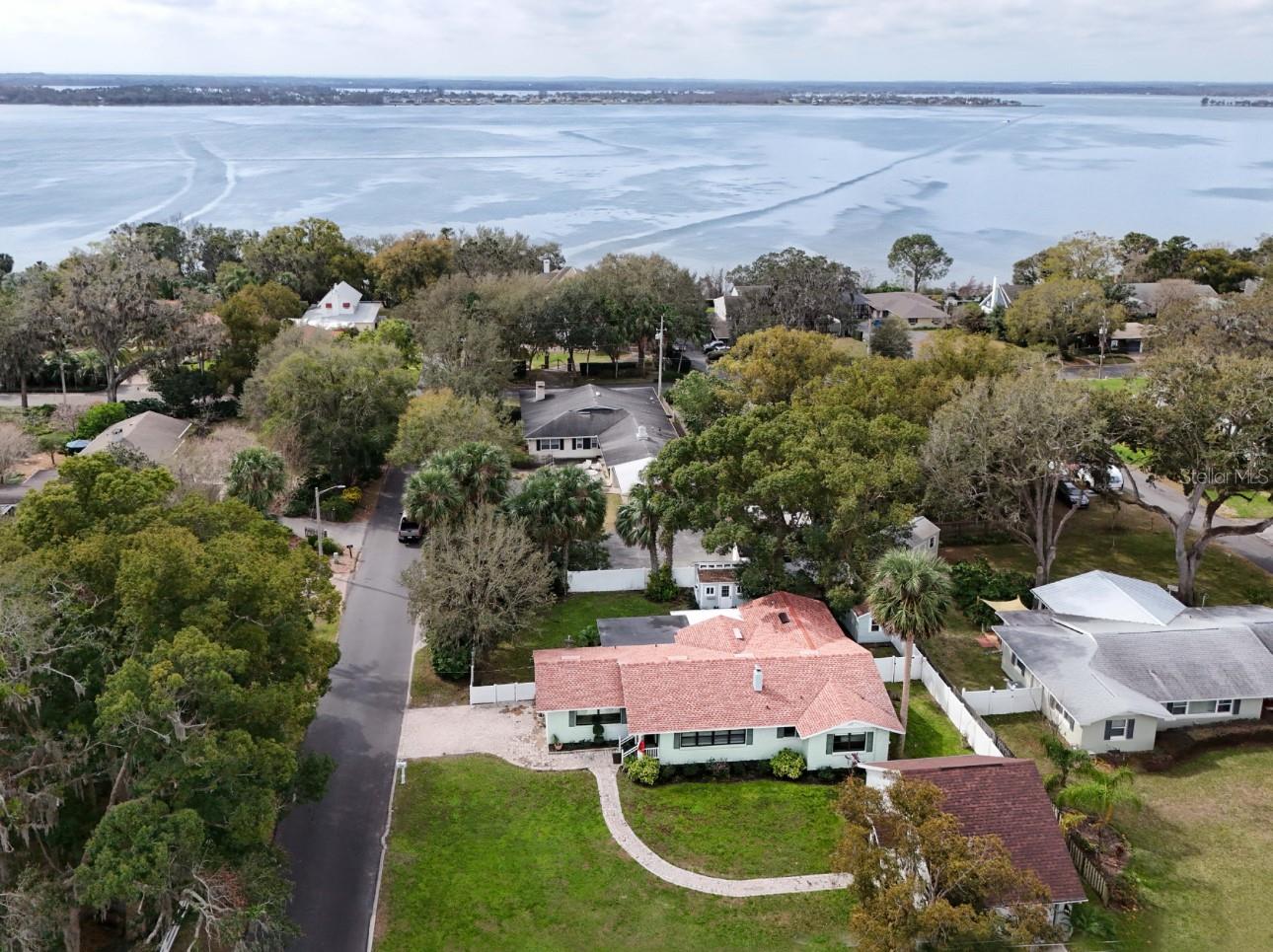 Mount Dora's Charm at its finest. This Unique 3 Bedroom 4 Bath home is nestled between Lake Gertrude and Lake Dora. Ride your bike or walk to either Lake or downtown within minutes. The updated Kitchen and open floor plan makes this home perfect for entertaining. The quartz countertops, soft-close cabinets, stainless steel appliances, and tile floors, makes cooking enjoyable. Adjacent to the kitchen is an oversized dining room with wood floors and built-ins. Beautiful wood-burning fireplace ,refinished wood floors , rounded archway all add to the character of this home. Step outside and enjoy both porches off the dining and kitchen areas. Enjoy the beautiful plants in your serene outdoor space. This home offers two large Master Suites and an additional bedroom that can serve as a guest room or office. The detached two-story garage is equipped with central heat and air and a full bath, making it a possibility for rental income , a mother-in-law suite, workshop, or man cave. The property includes a 10x12 "She Shed" with windows and transom lights. There is a 8 x 12 storage shed. Backyard is a private paradise enclosed with a vinyl fence. Schedule your showing Today!!!