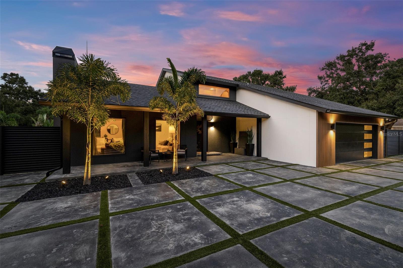 Welcome to 1008 Michigan Blvd, where modern luxury meets the heart of Dunedin’s most coveted location. Nestled directly across from Highlander Park, this fully renovated 5-bedroom, 3-bath masterpiece sits on just under a private fenced half-acre—a rare find in Dunedin and an absolute dream for anyone looking to live steps from Dunedin’s best amenities.From your front door, enjoy a short walk to the Dunedin golf course, Dunedin Fine Arts Center, the Pinellas Trail, the splash pad, tennis courts, and ball fields. Hop on your golf cart and be in Downtown Dunedin within minutes for dining, festivals, breweries, and waterfront sunsets. This is the lifestyle everyone wants—and at Michigan Blvd, it’s yours.Inside, the home has been reimagined with a new modern architectural style, soaring 14-foot ceilings (an impressive 18 feet in the foyer) and high-end finishes throughout. Every major system has been thoughtfully updated for long-term peace of mind, including:• 2024 new roof with hurricane straps• 2024 EAS custom impact-rated windows and sliders, including automated roller shades.• Three new A/C systems with ductwork• Updated electrical with generator transfer switch• Energy-conscious construction, and spray foam insulation with verified air sealing.The upstairs features separate zoning, making it ideal for guests, extended family, or a private second master suite.Outside, the property continues to impress with new James Hardie Architectural Panels, gutters, PVC wood-slat fencing, and all-new exterior lighting. The oversized double lot includes:• RV parking + plenty of room for your backyard pool oasis or an ADU• New textured concrete, turf, and irrigation• Front and back yard fencing• Low-Maintenance Landscaping for added privacy• An 8-car private driveway + 2-car oversized garage with custom cabinetry• Attic with decking for storageThis home truly blends location, luxury, and long-term durability—offering every modern upgrade a buyer could want while being surrounded by Dunedin’s most beloved parks, recreation, and community amenities. Oh wow awesome! THIS HOME WAS NOT AFFECTED BY RECENT/PAST HURRICANES AND HAS NEVER FLOODED.1008 Michigan Blvd isn’t just a home, it’s a lifestyle, a retreat, and a rare Dunedin opportunity. Come experience it for yourself.