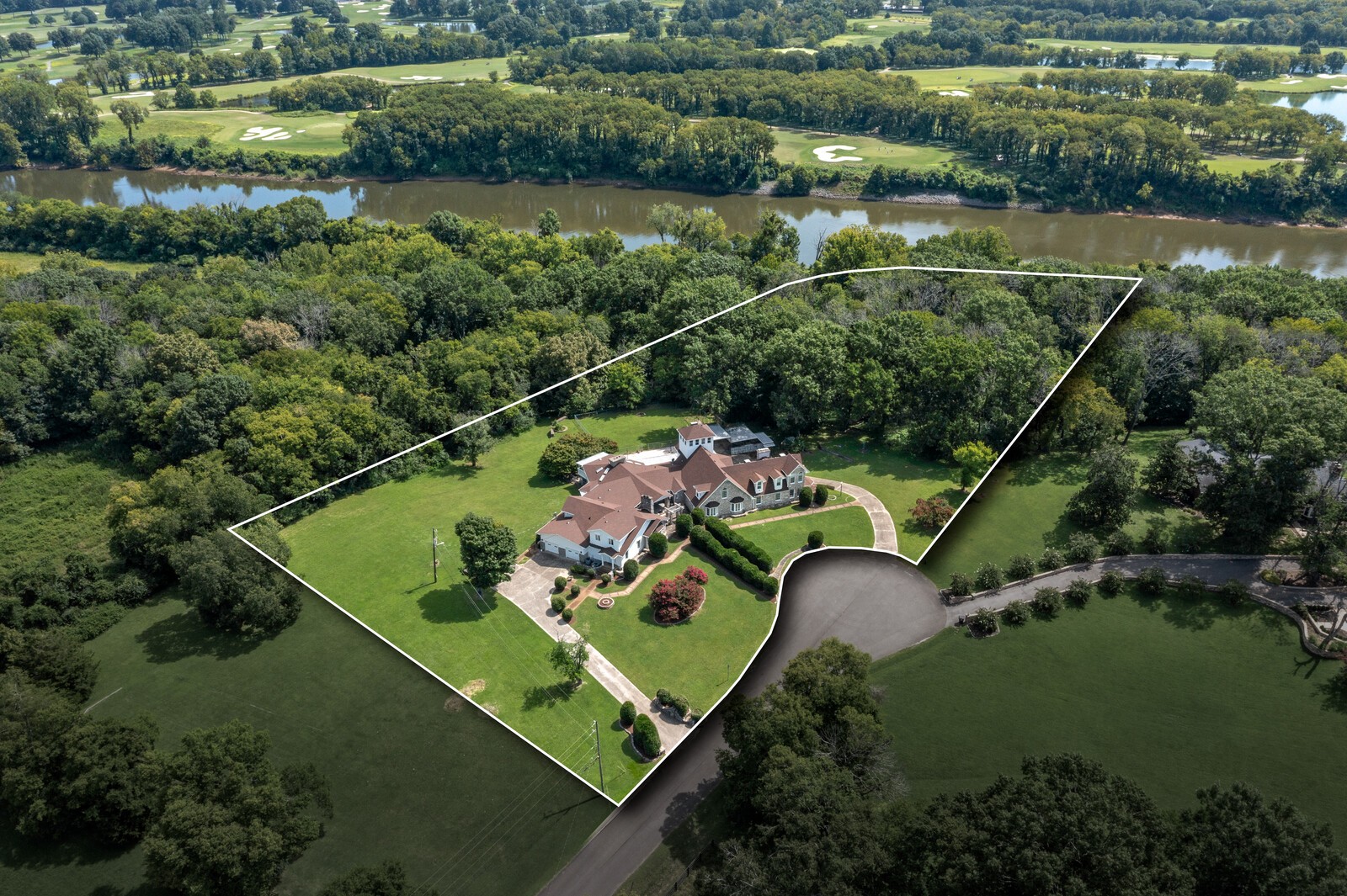 Amazing opportunity to renovate this incredible estate home located on 7.11 acres backing up to the Cumberland River with approximately 250 ft of water frontage. The home is approximately 13,336 square feet with endless possibilities.  Exterior has been freshly painted, new roof, 2 new Geothermal HVACs, pool was inspected and any necessary repairs made prior to 2025 winterization.   Professional measurement attached.  Too many rooms for MLS input fields.