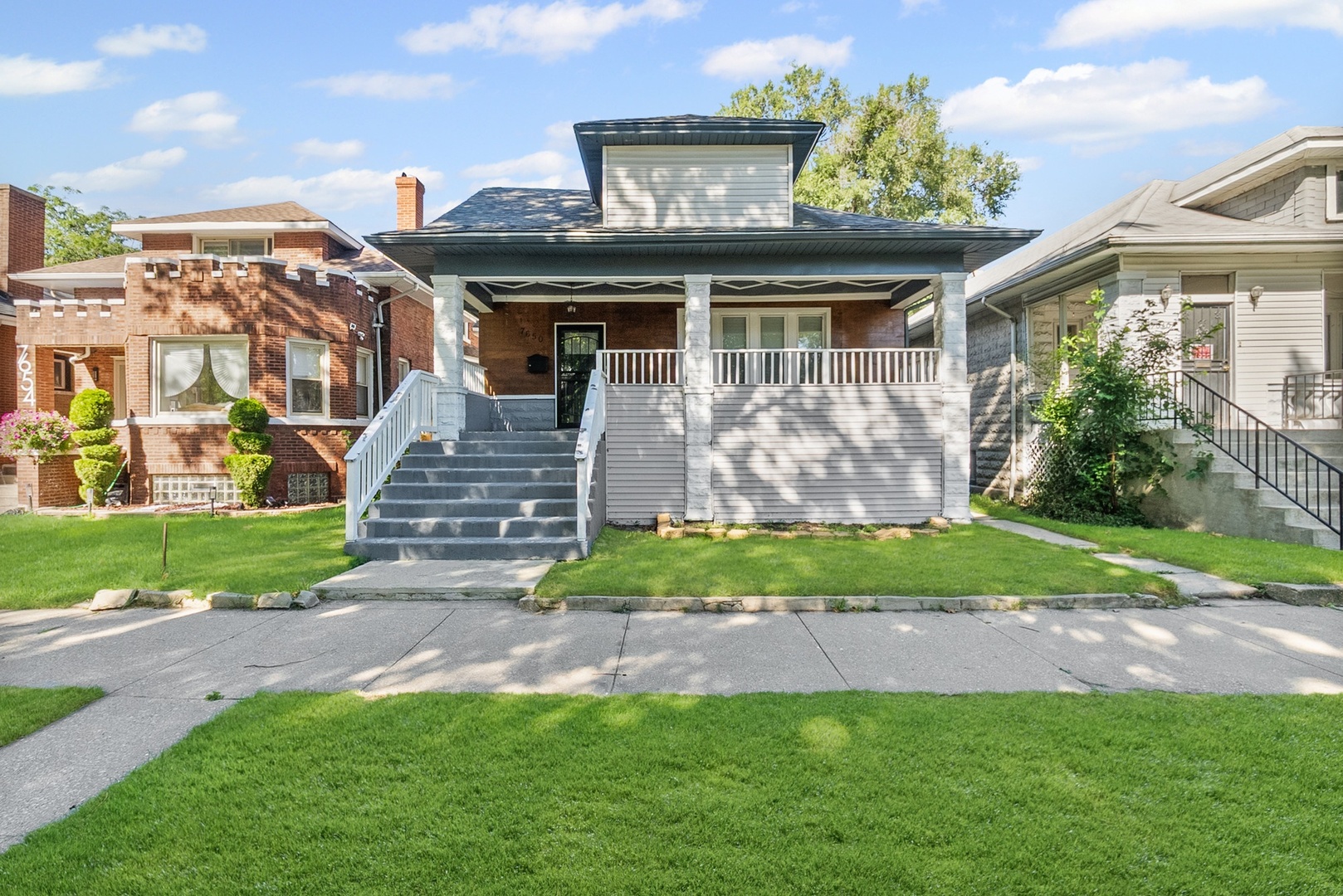Stunning Fully Renovated Bungalow - A South Shore Gem!    Welcome to your dream home! This breathtaking 6-bedroom, 4-bathroom bungalow in the heart of South Shore is a rare find, perfectly blending modern luxury with functional living. Nestled on a tranquil, tree-lined street, this exquisite property offers a lifestyle of refined elegance and comfort.    Designed by iFlipChicago, this contemporary masterpiece features a spacious open floor plan that seamlessly combines intimate spaces with expansive entertainment areas. The main level fireplace creates the perfect ambiance for both large gatherings and family moments.    The designer kitchen is a chef's delight, featuring a stylish tile backsplash, 42-inch cabinets, an impressive 8-foot island, and top-of-the-line Samsung stainless steel appliances. The second-floor owners' suite is a luxurious retreat, complete with a sumptuous full bath, walk-in closet, and an additional bedroom and full bath, along with convenient second-floor laundry!    The fully finished basement is perfect for hosting parties or relaxing with loved ones, offering two additional bedrooms, a full bath, and another laundry room. Your peace of mind is assured with essential updates, including a drain tile system, fairly new plumbing, electrical, heating & cooling with new AC and furnace, and energy-efficient windows.    Step outside to your expansive front porch, ideal for sipping coffee while enjoying peaceful mornings, or retreat to the sun room with your favorite book. The exterior features include wooden privacy fencing, a 2-car garage, and a spacious patio, perfect for summer barbecues.    Conveniently located just blocks from the Metra, South Shore High School, parks, and CTA, plus a mile from Lakeshore Drive, the beach, and Jackson Park Golf Course, this home offers the perfect blend of urban living and suburban tranquility.    Don't miss out on this extraordinary opportunity! Schedule your showing today!
