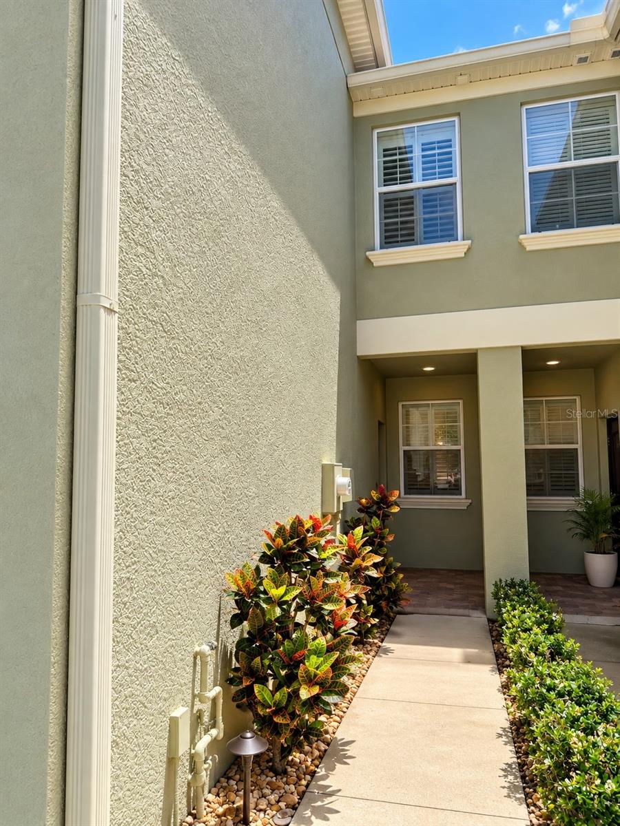 Virtually Staged. Welcom home to 9568 Trumpet Vine Loop, a spacious 3-bedroom, 2.5 - bath townhome located in the desirable Thousand Oaks East community of Trinity. Offering over 2,000 square feet of living space, this home combines a comfortable open layout with the convenience of low-maintenance Florida Living.The main level features an open living and dinning area with plenty of natural light, creating an inviting space for both relaxing and entertaining. The kitchen offers, granite countertops, wood cabinetry, stainless steel appliances, ample storage and casual dinning. A convenient half bath completed the first floor.Upstairs, all three bedrooms are thoughtfully separated for privacy. The spacious primary suite features a walk-in closet and private bath, while two additional bedrooms share a full guest bath. The laundry area is also conveniently located upstairs.Step outside to the fenced and paved rear patio - a great spot to enjoy your morning coffee, unwind at the end of the day or create your own outdoor entertaining space.  An attached one car garage provides additional space and storage.Located just minutes from shopping, dinning, medical facilities, and everyday conveniences, with easy access to SR 54 and major roadways this home puts the bestof the Trinity area within easy reach.