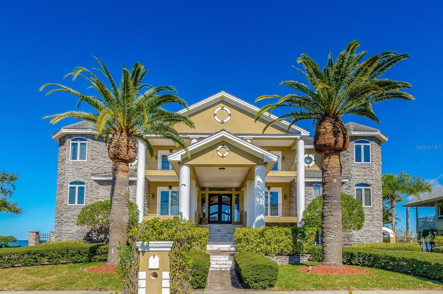 One or more photo(s) has been virtually staged. EXCEPTIONAL WATERFRONT HOME NOW AVAILABLE! SELLER IS ALSO OFFERING OWNER FINANCING OR A LEASE-PURCHASE OPTION TO BUY! Located in the exclusive, guard-gated community of Harbour Watch, this 5-bedroom, 6-bath waterfront home with an elevator offers outstanding Gulf and Anclote River basin views the moment you walk in. The layout, size, and features make this home ideal for anyone looking for comfort, space, and true waterfront living. The kitchen is set up for serious cooking and entertaining, with a commercial-grade cook station, a separate hibachi-style station, and Sub-Zero refrigerator and freezer units. The open design makes meal prep and gatherings easy. The home also includes a theater/movie room for relaxing and a large game room with its own second full kitchen, perfect for hosting family and friends. The great room features beautiful water views, built-in cabinetry, a fireplace, and an open flow to the kitchen. The primary suite is a true retreat with Gulf views, custom built-ins, a fireplace, and a private balcony. A spiral staircase from the balcony leads up to a 4th-floor widow’s watch with incredible open-water views. All secondary bedrooms are generously sized and include their own private bathrooms and walk-in closets with built-ins.Additional features include three butler’s stations, two laundry rooms, and elevator access to all levels. The 4-car side-entry garage provides plenty of parking and storage. Outside, the home includes a large dock with a lift for a sizable boat, plus additional lifts for smaller watercraft.Harbour Watch offers 24/7 guarded entry along with a pool, spa, clubhouse, tennis and pickleball courts, and a playground. The location is close to shopping, dining, beaches, and essential services, and is about 45 minutes from two major airports, providing both privacy and convenience.