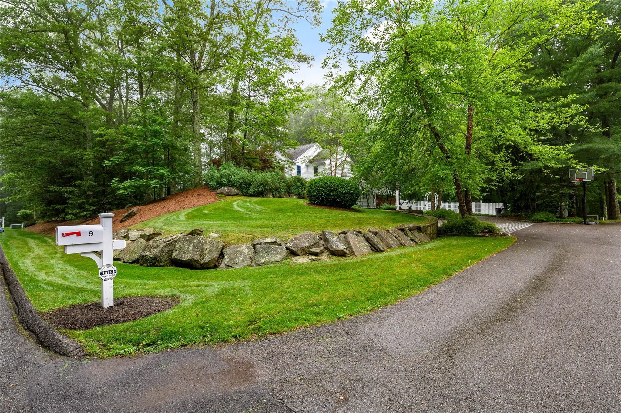 Welcome to this classic 4-bedroom, 4-bathroom Colonial sited at the beginning of a quiet cul-de-sac. With timeless white siding and a two column portico entry, this home offers space, comfort, and elegance in a peaceful setting. Step into a gracious entry hall that leads to a formal dining room and living room. The eat-in kitchen with granite counters and a center island, features top-of-the-line Bosch, Miele & Sub-Zero appliances, pantry and doors to access the deck that opens to the flat, rear yard. Kitchen overlooks and flows seamlessly into a bright and airy family room with a fireplace and four skylights, creating a warm and inviting space. Rounding out the first floor space is a large private office, ideal for today's work from home lifestyle and a first floor laundry room with utility sink and storage.  Upstairs, the spacious primary suite boasts refinished hardwood floors, an updated ensuite bath with jacuzzi tub and modern shower, plus dual walk-in closets and an extra closet perfect for shoes and handbags. A cozy built-in cushioned window seat with floor-to-ceiling bookshelves sits just outside the suite, offering a quiet reading nook. Three additional bedrooms, all with brand new carpet, a full hall bath and pull down attic complete the second floor. 
The finished lower level offers two expansive rooms with storage closets, perfect for a playroom, and gym, or guest space, along with a full bath, kitchenette (counter top, microwave and small fridge), and more than ample storage. 
Additional highlights include a whole-house generator, fenced rear yard, direct lower-level walkout and a newly outfitted garage with slat board wall and epoxy textured floor . A rare combination of classic charm and thoughtful updates—ready to welcome its next owners.
