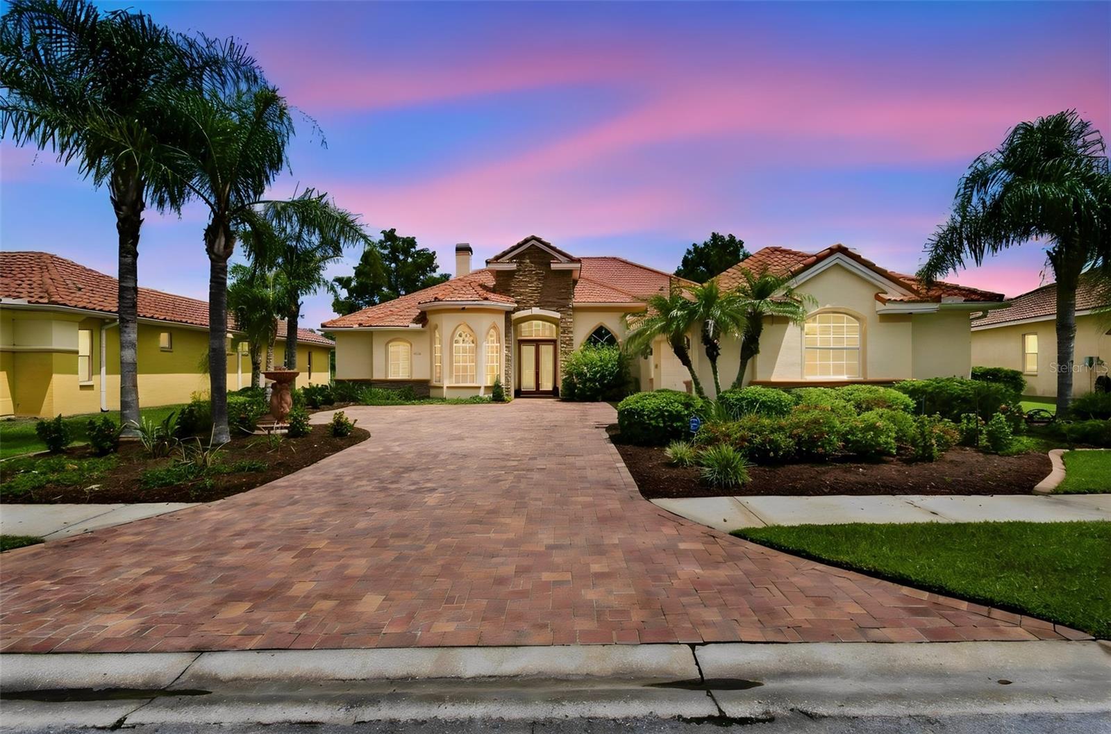 BRAND-NEW 2026 UPDATES, A FORMER 4 BEDROOM plus OFFICE 3 BATH MODEL POOL & SPA HOME, AND A VIEW THAT CAPTURES YOU THE MOMENT YOU WALK THROUGH THE DOOR! Beautifully refreshed with a BRAND-NEW A/C (2026), ALL-NEW SHERWIN-WILLIAMS DESIGNER-SELECTED INTERIOR PAINT (2026), AND ALL-NEW LVP FLOORING THROUGHOUT (2026) to compliment any color scheme. The story begins as you arrive. A soft lemon-yellow exterior, striking TILE ROOF, brick-style pavers and extraordinary flowers and landscaping create beautiful Mediterranean curb appeal. Follow the pavered courtyard to the front door, step inside—and your eye travels straight through the home to the sparkling pool and hot tub, peaceful pond and stunning, private natural backdrop beyond. Expansive windows make the water, birds and nature part of the home from the moment you enter. Originally a model home, special architectural details remain throughout. The family roomfeatures double tray ceilings, curved wall surfaces and decorative niches, while the kitchen offers solid surface countertops and GAS cooktop stove. Outside is where Florida living takes over. The pool, hot tub and pavered lanai overlook the pond, creating an incredible setting for morning coffee, afternoons by the pool or evenings watching the birds and sunset over the water. With sink access and a small refrigerator already in place, the lanai also offers an ideal foundation for a future full outdoor kitchen. All of this is within the gated Hernando Oaks golf community, where golf memberships are available and the clubhouse offers a restaurant, pickleball and practice facilities through a modestmonthly social membership. Shopping, restaurants, medical facilities and major roadways are conveniently nearby. Pristine, move-in ready and beautifully updated, this is more  than a home that checks the boxes. It's a home you'll remember for the way it makes you feel—and for a view that simply can't be recreated.
