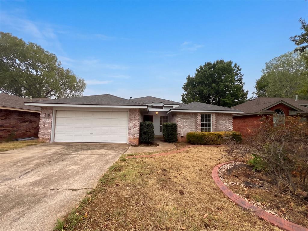 1709 Baron Dr is a single-story Norman home with three bedrooms, two bathrooms and 1,528 square feet of living area. The kitchen combines white cabinetry with counter space around a cooktop, sink and wall oven. A built-in hutch adds storage to the dining area. In the living room, a fireplace and shelving face a row of windows overlooking the backyard. The primary bedroom has an attached bathroom and a walk-in closet, with two additional bedrooms along the hall. A covered rear patio extends beside the lawn, while the laundry area and attached two-car garage serve the opposite side of the home. Included 100-Day Home Warranty with buyer activation