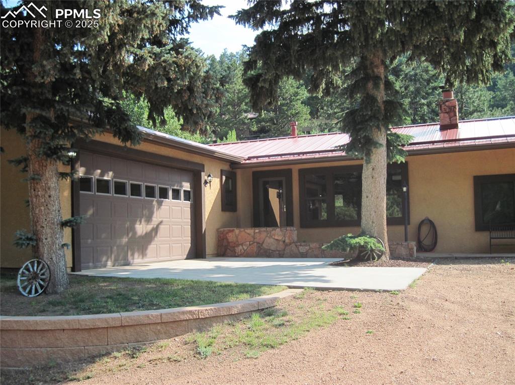 Green Mountain Falls! This is a remarkable home in an extraordinary community. This home has a large living room with a wood-burning fireplace. The welcoming cabin vibe is unmistakable, with all the conveniences of a modern home.  The ranch-style home has 3 bedrooms, 2 baths, a breakfast nook, and a full dining room. The home office has a couple of steps and ample storage space. The kitchen is well-appointed with stainless appliances, a gas range, a dishwasher, and a microwave. Washer/dryer hook-ups are well located. The fenced backyard has two large storage sheds that offer even more storage. The attached oversized garage is a car lover’s dream with a black and white checkered floor and a custom logo in the driveway. The home has a metal roof, stucco siding.