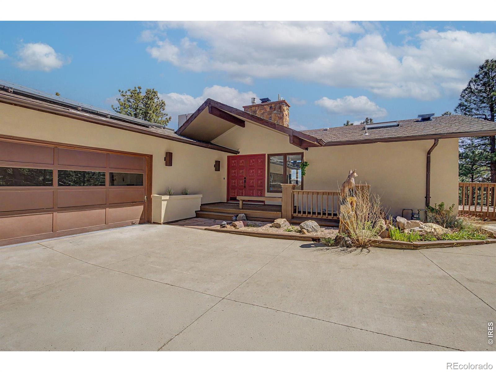 Perched in the foothills just 10 minutes from Pearl Street, this exceptional Boulder residence offers a rare balance of mountain serenity and city convenience. Set on a private acre, the property provides both seclusion and connection with thoughtfully designed indoor and outdoor living spaces that capture the essence of Colorado living framed by sweeping views of the city and plains below and frequent visits from Deer, Turkey and Foxes.The upper level is designed for both everyday living and elevated entertaining. An accordion style glass door seamlessly connects the Great Room area to the outside upper deck creating a true indoor-outdoor experience ideal for gatherings or quiet evenings taking in the views. Each room on the upper level is filled with natural light enhanced by expansive windows and skylights that bring the outdoors inside.Designed with sustainability and comfort in mind, this home features a highly efficient dual-zone hydronic heating system paired with fully owned solar panels and enhanced insulation. The result is a thoughtfully engineered residence delivering year-round efficiency, low-maintenance living, remarkably low utility costs, and evenly distributed heat throughout. This Home is complete with designer finishes and showcases curated interior enhancements and new lighting both inside and out, creating a warm and refined ambiance.The kitchen features modern appliances, hard stone flat surfaces and backsplash, black composite sink and touch faucet to create a clean, functional layout that complements the home's blend of contemporary comfort and mountain-inspired design including it's own breakfast nook deck. Whether you're working from home, entertaining, or seeking a peaceful retreat, this property offers exceptional versatility. The fully fenced acre provides added privacy and usability, while the location delivers effortless access to Boulder's most sought-after amenities-offering a seamless balance of tranquility, views, and convenience.