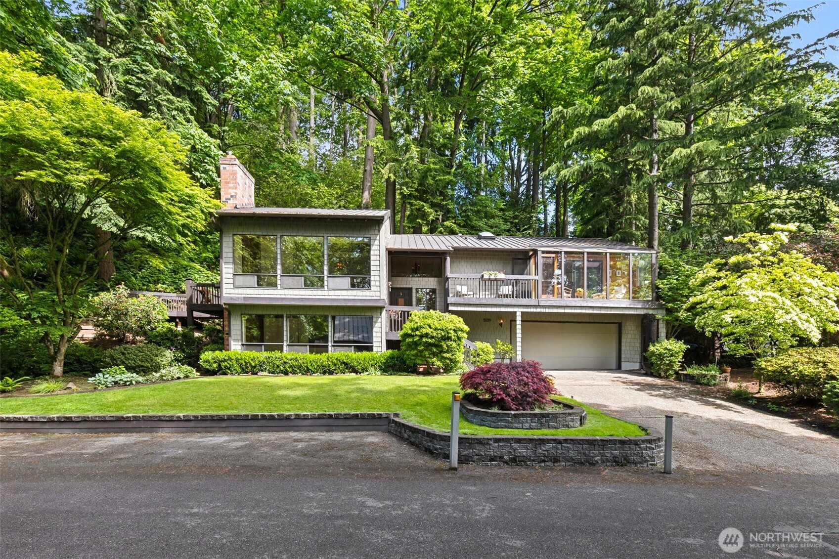 Tucked away on a peaceful, private stretch of East Mercer, this beautifully maintained residence offers an incredible opportunity to live among nature on an expansive 23,594 sqft lot. Backing to greenbelt, the prprty feats its own walking trail, vibrant landscaping & privacy. The home offers plenty of parking. Durable metal roof & timeless architecture. Whether you choose to preserve its vintage charm or update it to your style, the possibilities are endless. Functional & filled with natural light-connecting seamlessly to the peaceful surroundings w large windows-making indoor-outdoor living effortless.Mins from top-rated schools, parks, & easy frwy access. Mercer Island living at its best w/ room to breathe, grow & create something special
