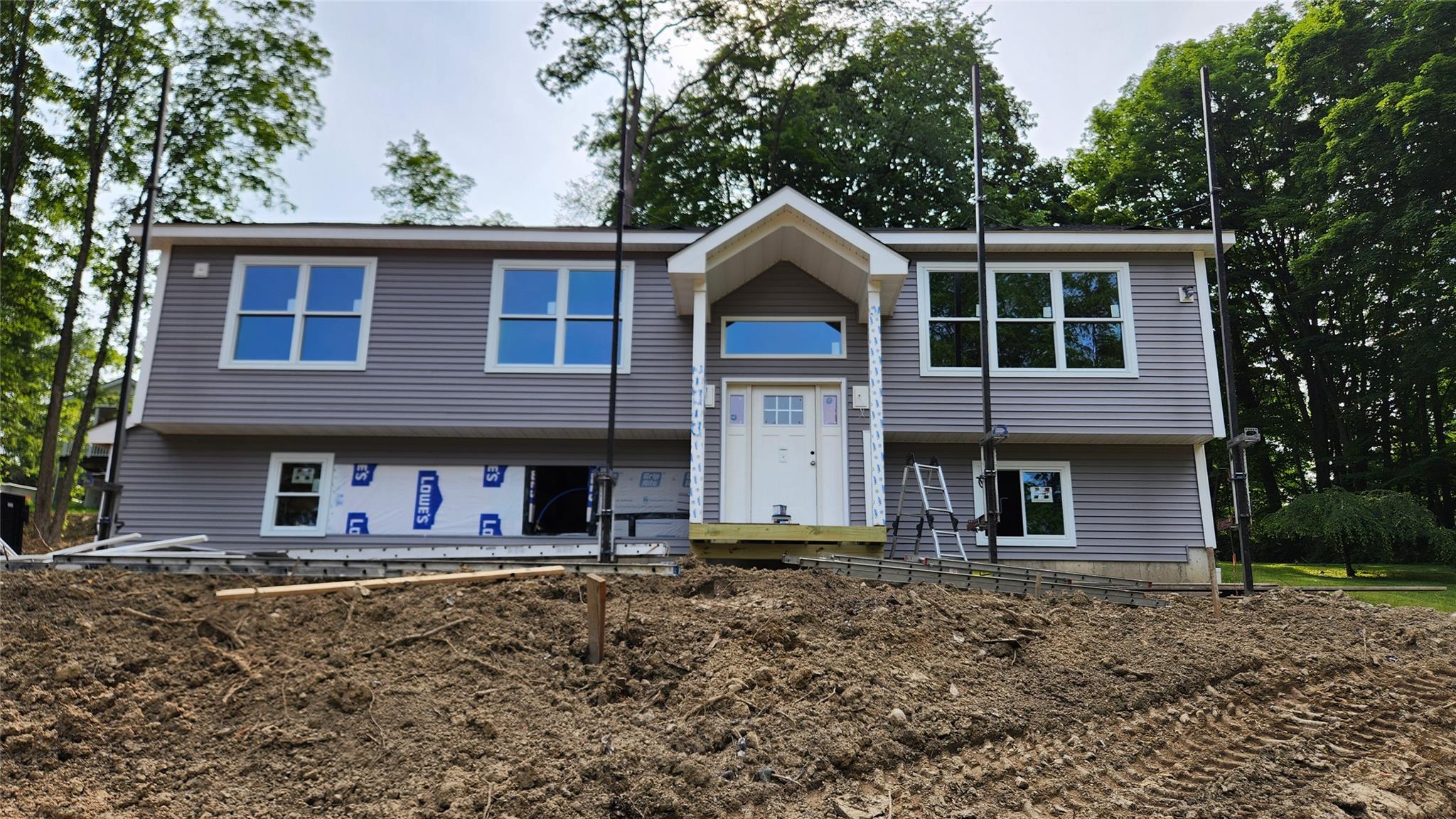 New Construction Raised Ranch Offering 3 Bedrooms & 3 Full Bathrooms on Just Over 1/3 of an Acre. Set Atop a Gentle Hill, This Home Enjoys Elevated Views, Excellent Natural Light, and a Private Feel, Bordered by Wooded Town Owned Land. Located on a Quiet Road, Soon to be Paved and Dedicated as a Public Street, with Only a Few Neighboring Homes. The Open Concept Main Living Area Features Approximately 10 Foot Ceilings in the Kitchen, Dining, and Family Room, Creating an Airy and Spacious Atmosphere Ideal for Modern Living. Quality Finishes Throughout, with Access to a 2 Car Garage and Additional Space on the Lower Level. Conveniently Located Close to Shopping, Dining, and More. A Rare Combination of New Construction, Privacy, and Everyday Convenience. Don’t Miss This Opportunity!